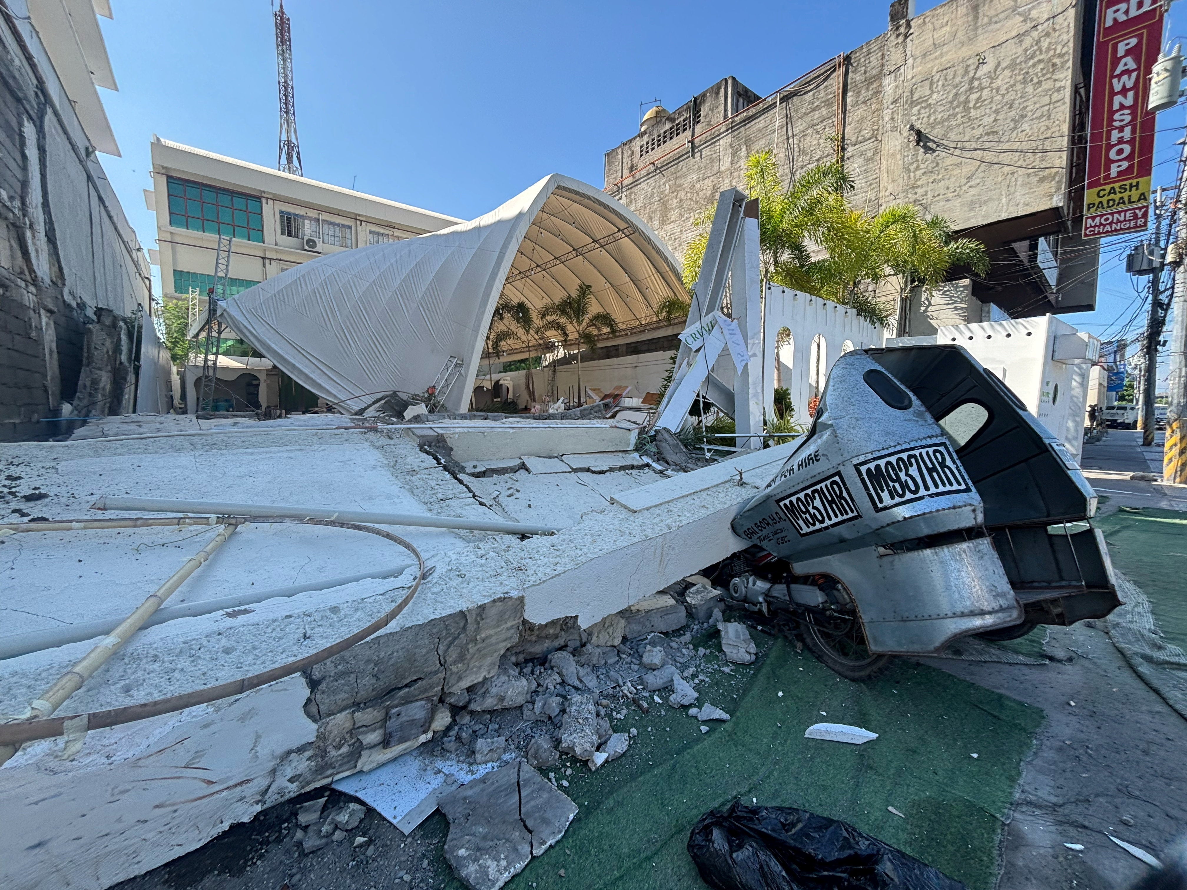 A damaged vehicle after a magnitude 7.8 quake in General Santos, Mindanao Island (Reuters)