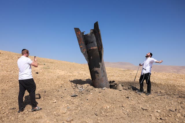 A fallen rocket half-buried in the ground on the outskirts of Jericho on June 8, following Iranian and Iran-backed Houthi rebel attacks