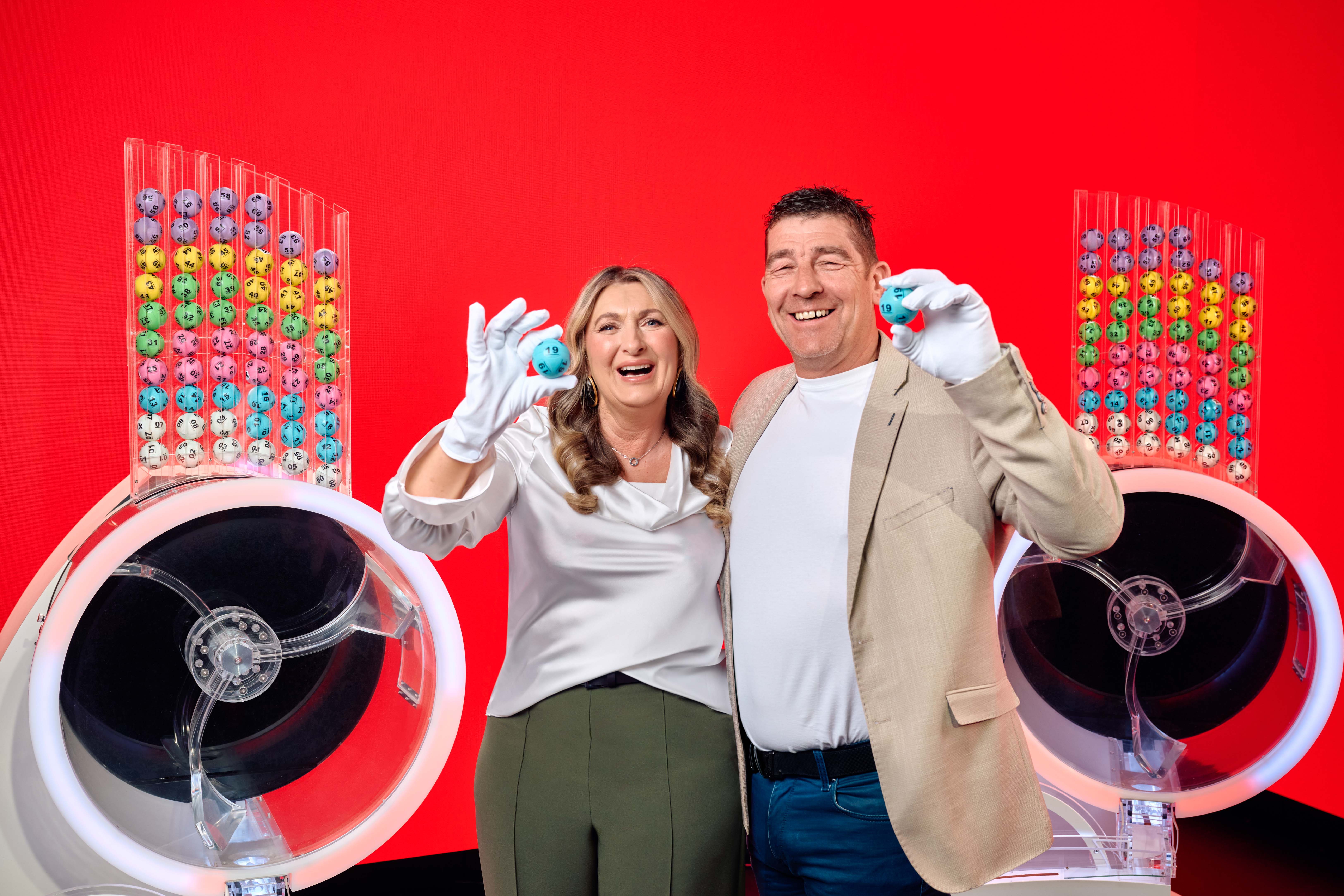 Chris and Geraldine Bradley, who won £3.5m on Lotto in 2006, alongside the two draw machines to mark the new two-round format