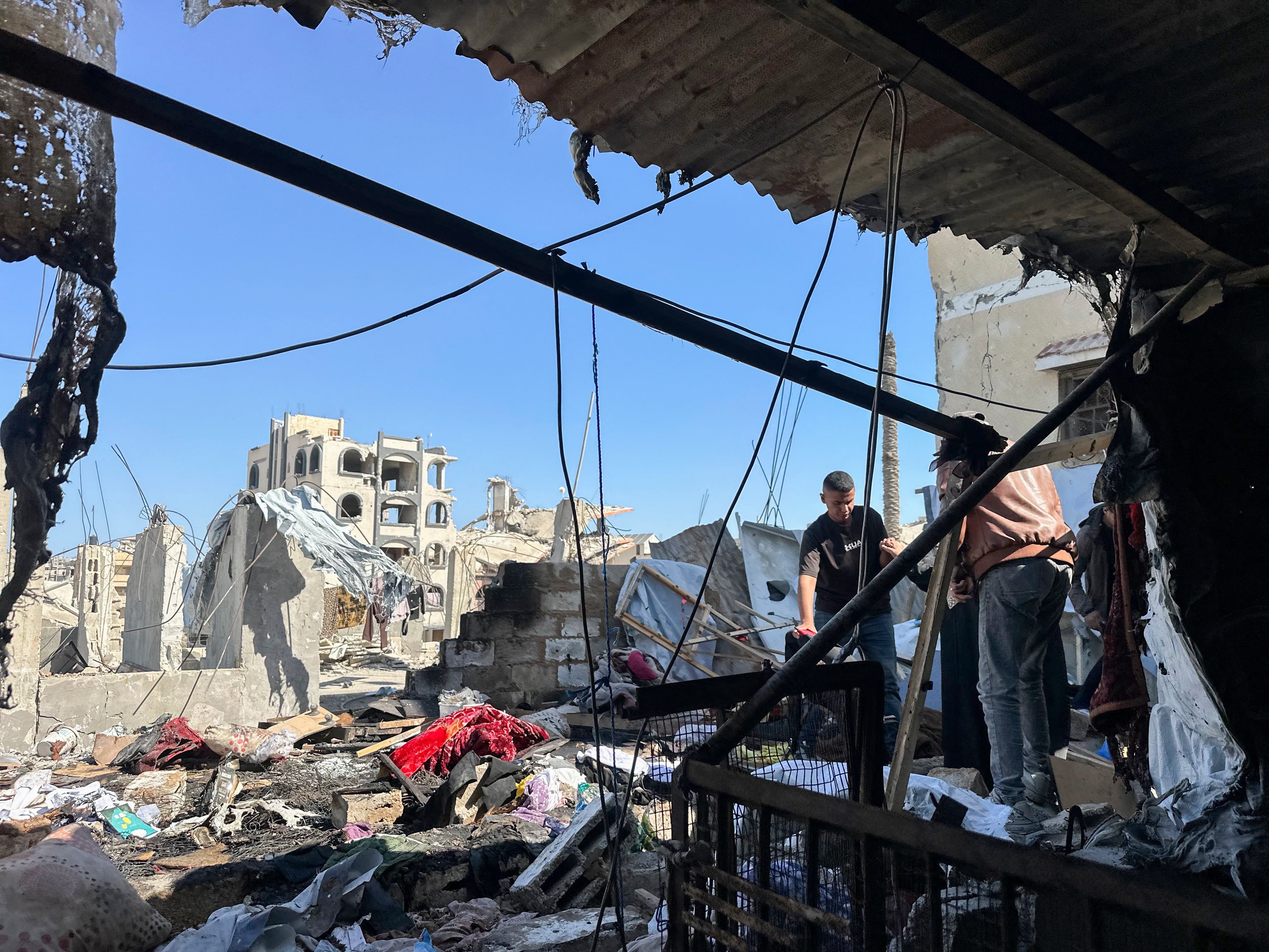 People stand among the rubble of a destroyed building in Khan Yunis, Gaza Strip, on June 6 (AFP/Getty)