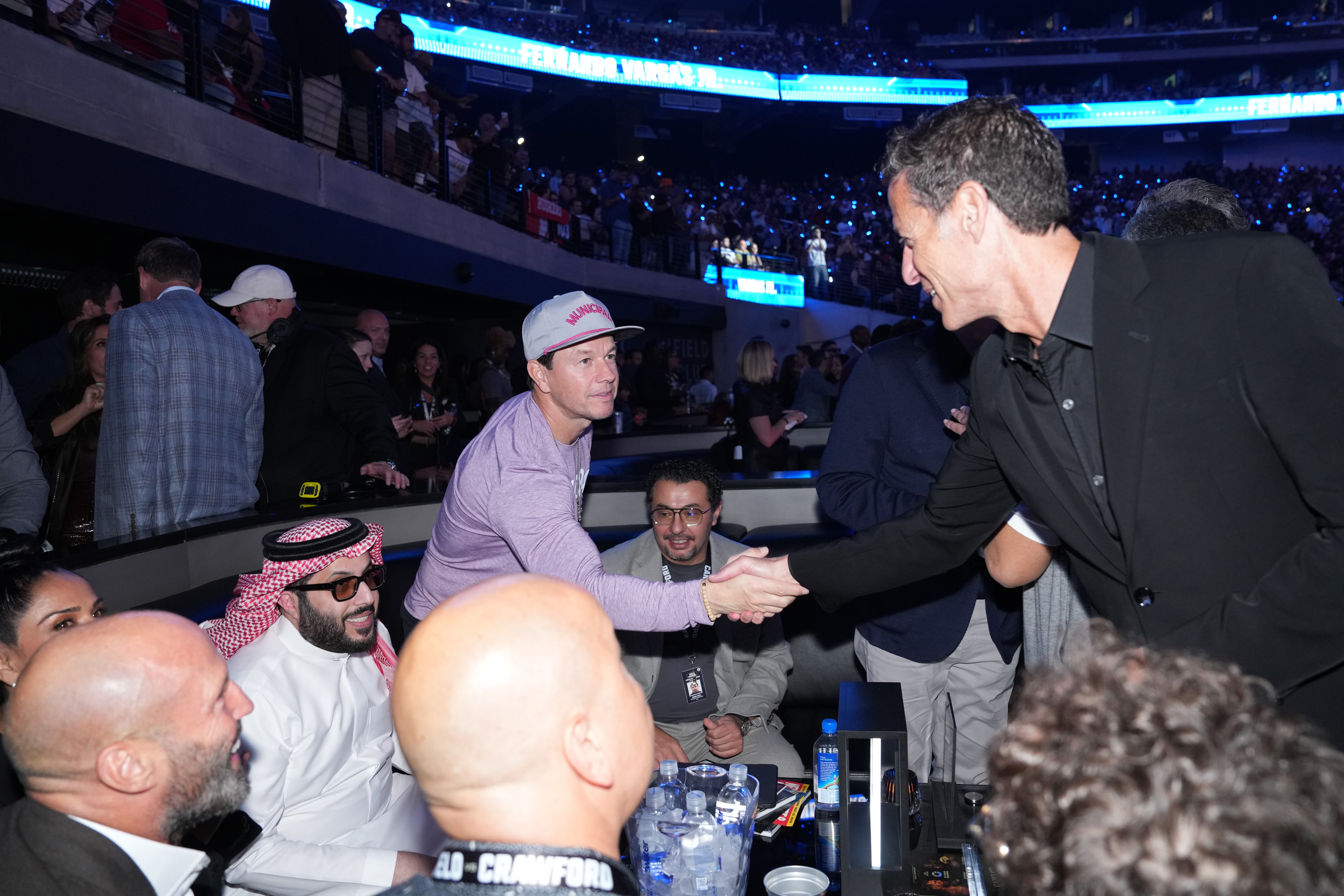 TKO Group Holdings may lose $30 million on the UFC’s White House event, says president and chief operating officer Mark Shapiro, left, seen here shaking hands with actor Mark Wahlberg at a boxing match in Las Vegas
