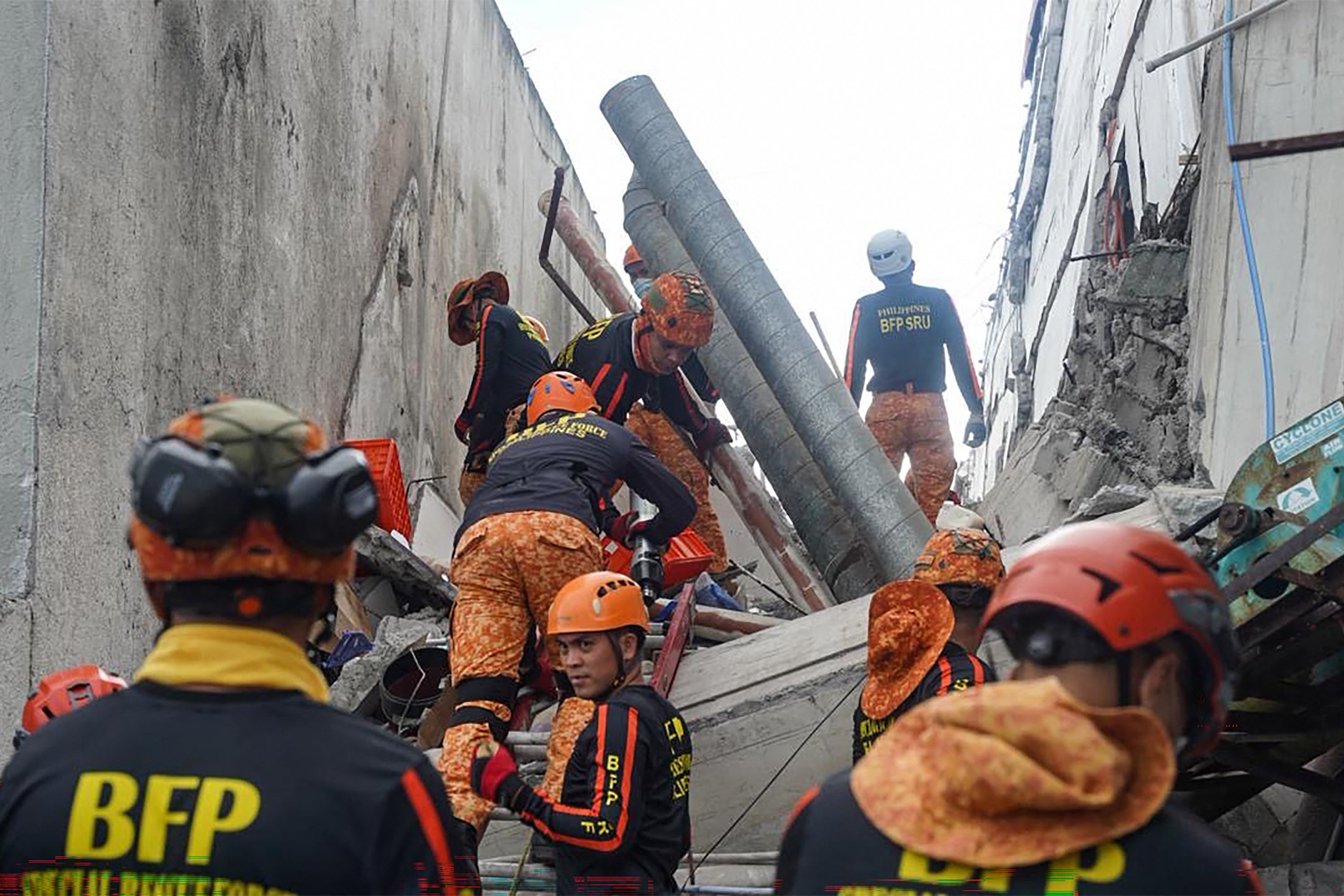 Responders conduct a rescue operation at a collapsed building after a 7.8 magnitude earthquake in General Santos City (AFP/Getty)