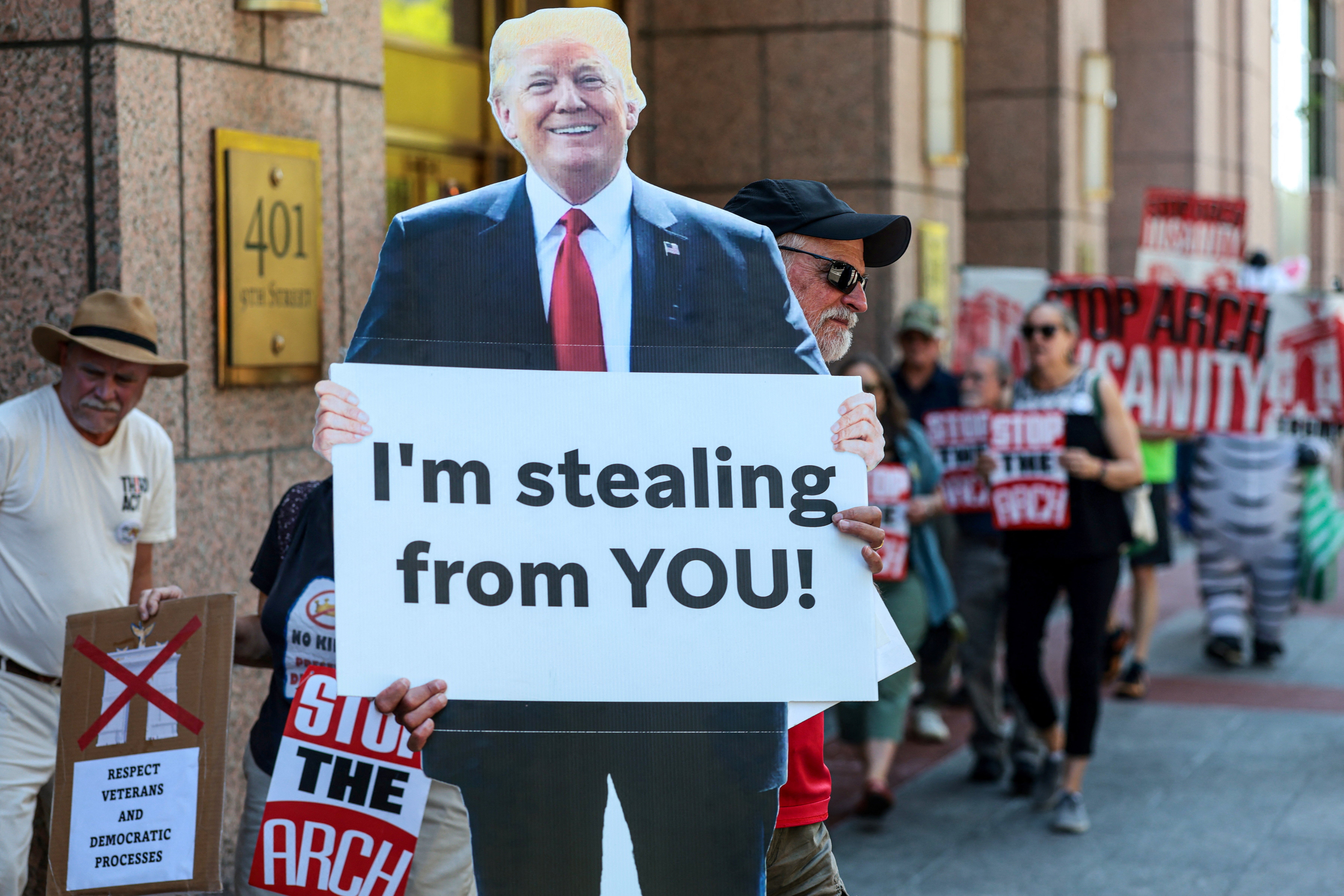 A protester holds a cutout of President Donald Trump during a demonstration against the president’s proposed triumphal arch before the public comment period of a National Capitol Planning Commission meeting in Washington on June 4, 2026