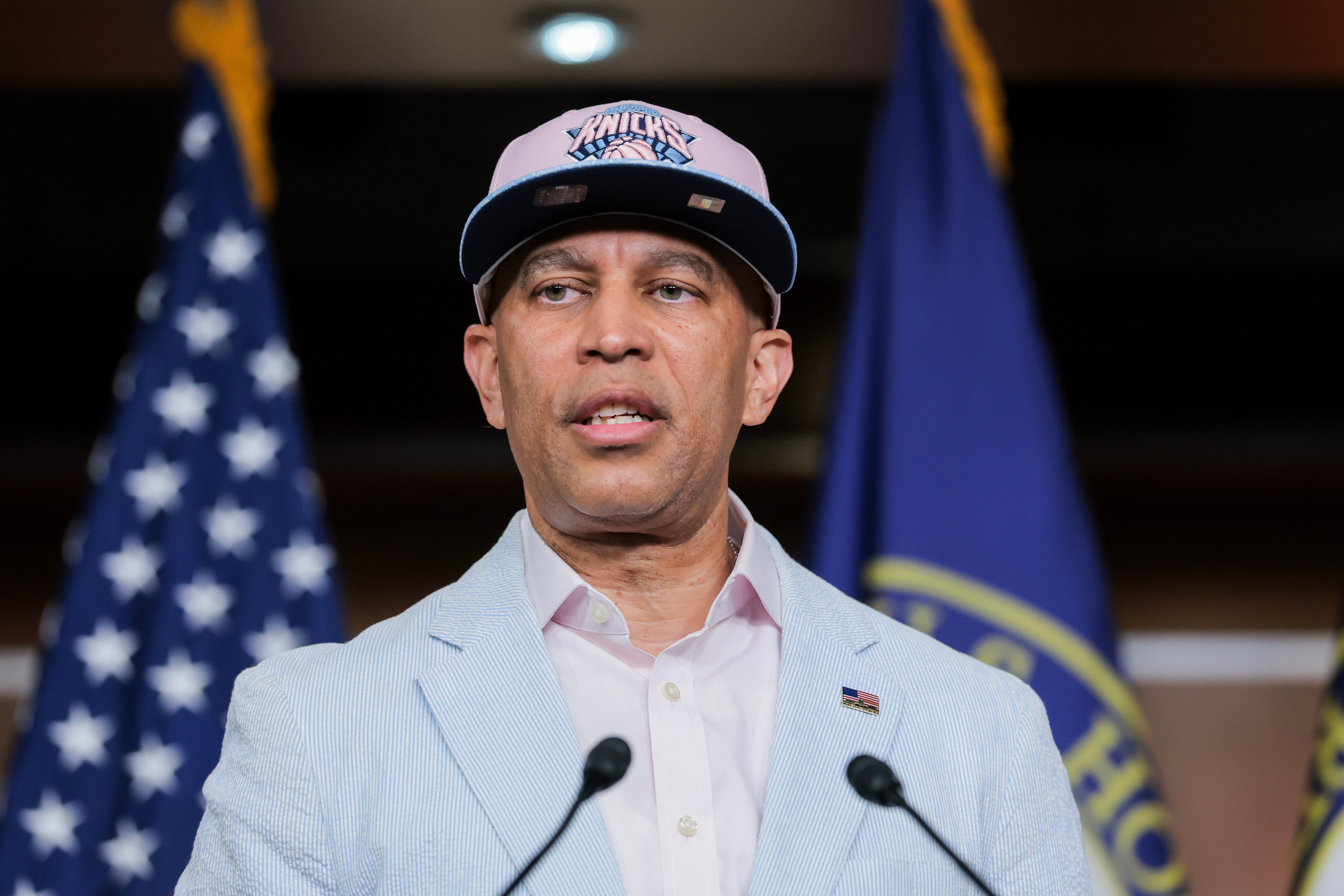 House Minority Leader Hakeem Jeffries speaks to reporters Monday while wearing a New York Knicks hat (Getty Images)