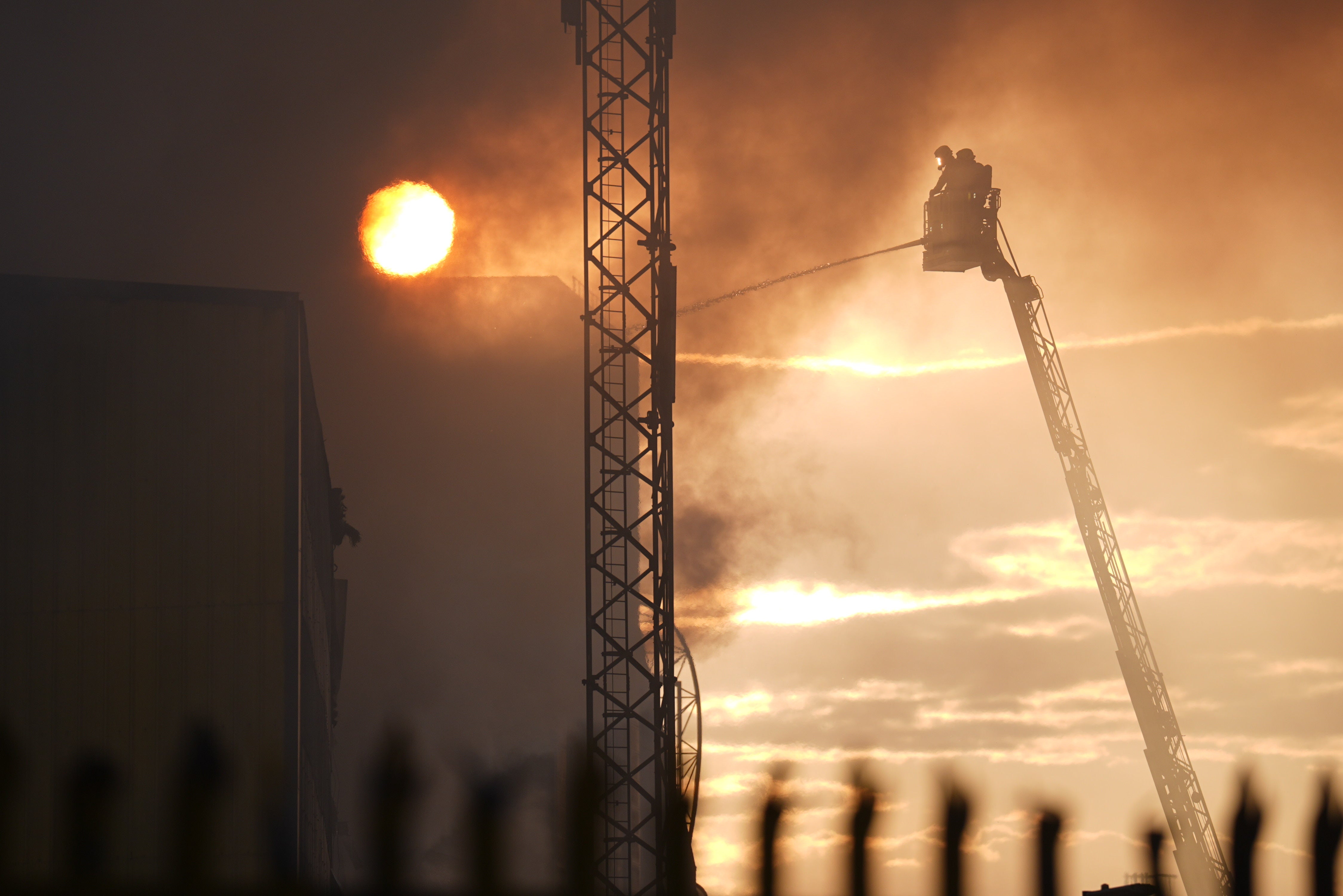 Firefighters use an aerial ladder platform at a fire at the Landmann Way Reuse and Recycling Centre in south London (James Manning/PA) (PA Wire)
