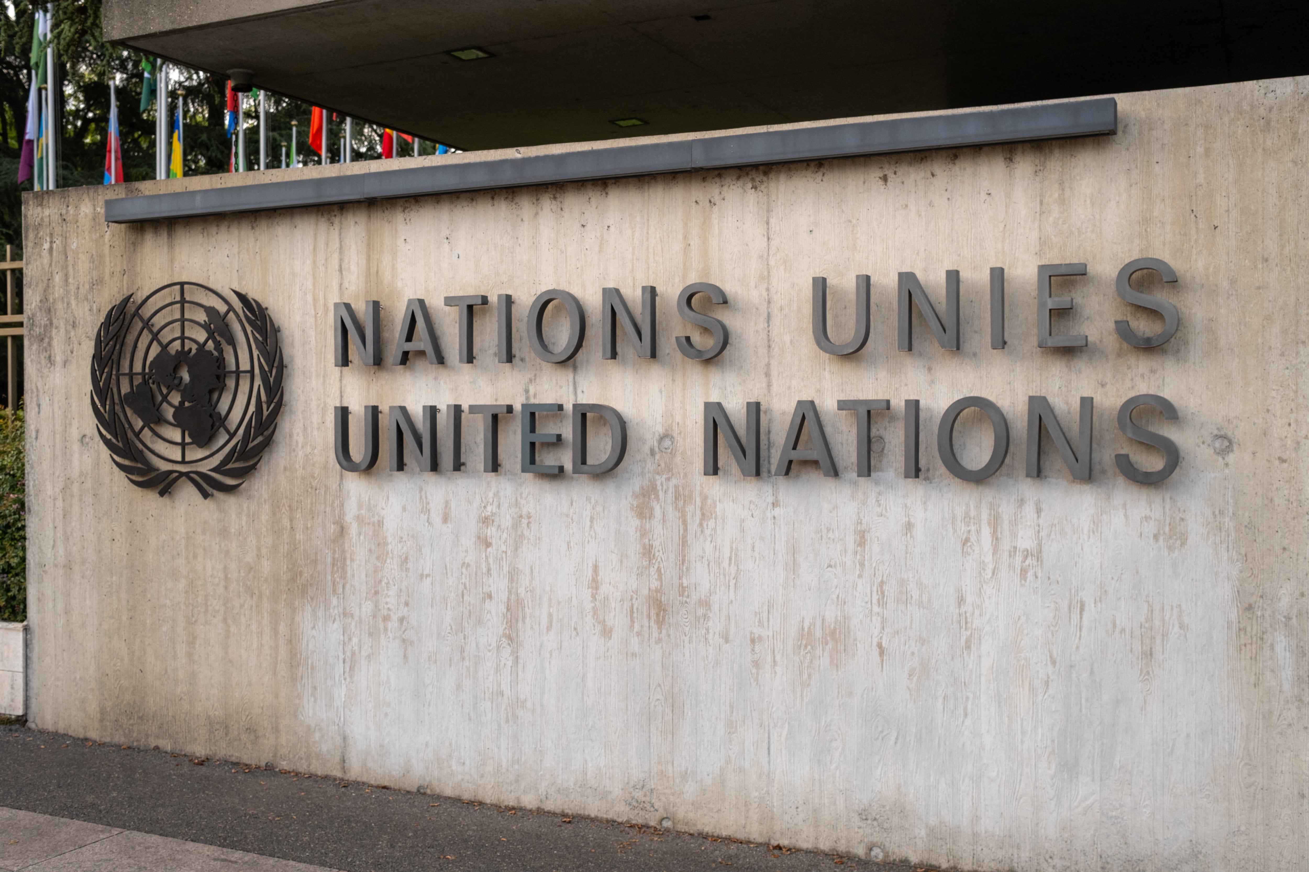 Close view of the United Nations sign on the entrance wall of the Palais des Nations
