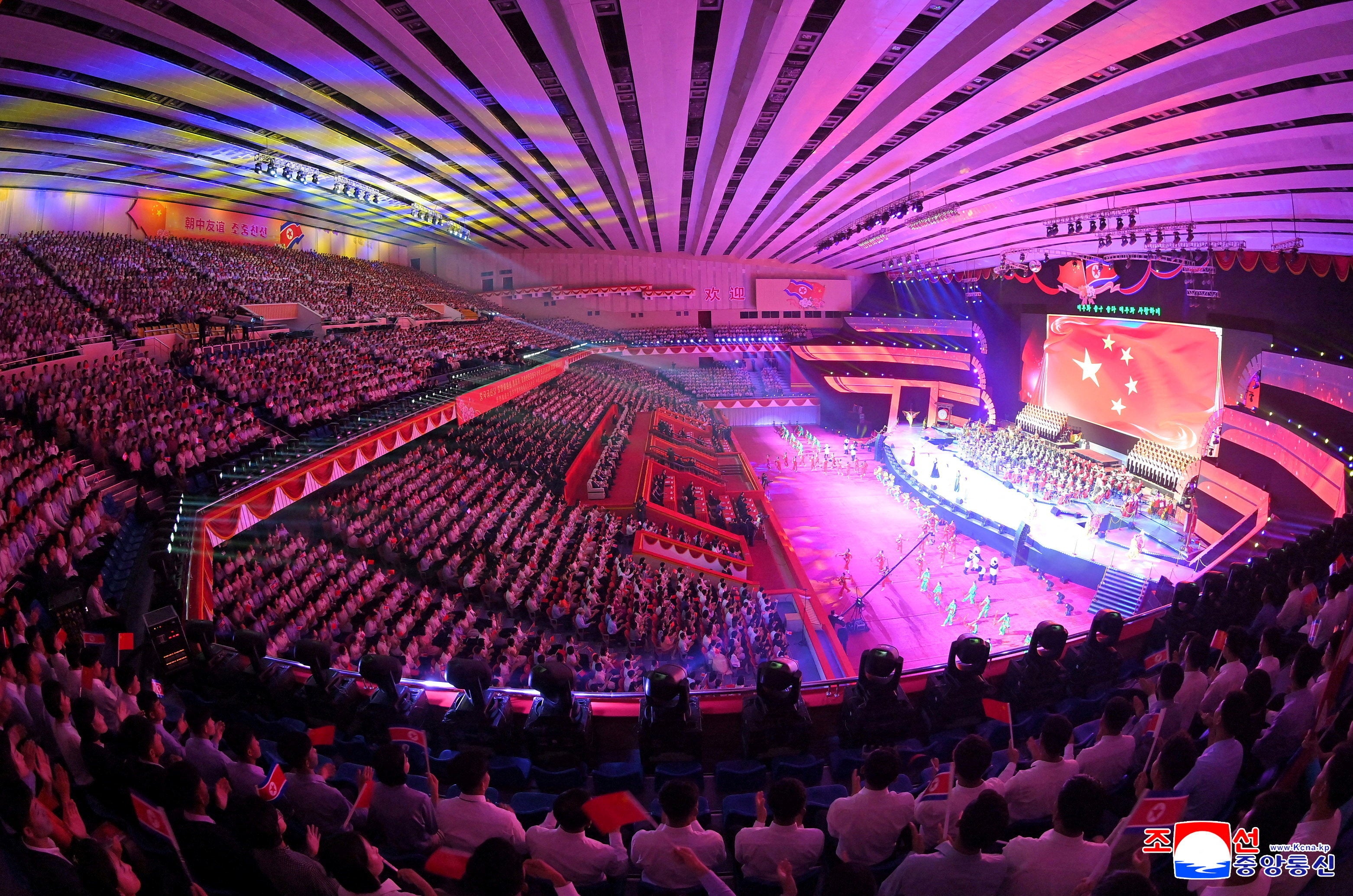 The flag of China is displayed on a screen during a performance at the Pyongyang Indoor Stadium, during Chinese President Xi Jinping's state visit in Pyongyang, North Korea