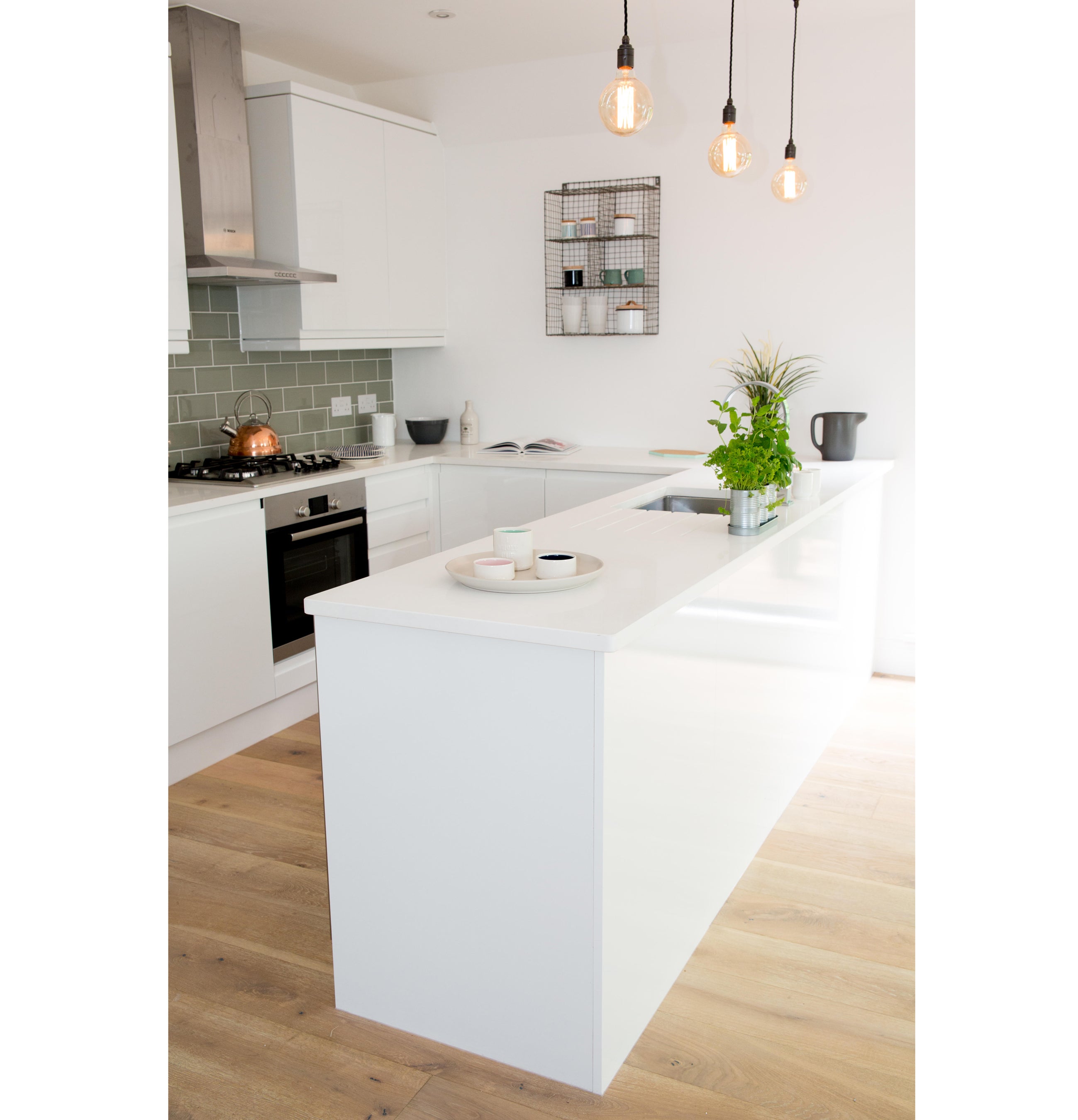 Contemporary kitchen with island and pendant lighting (Alamy/PA)