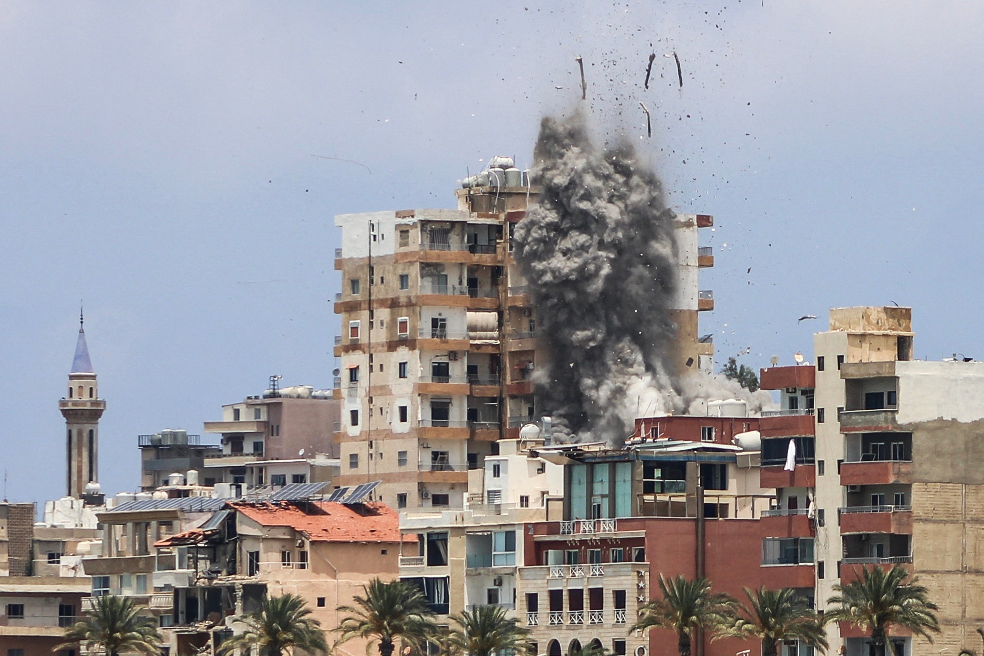 Smoke and debris rise following an Israeli airstrike in Tyre on June 9 (AFP/Getty)