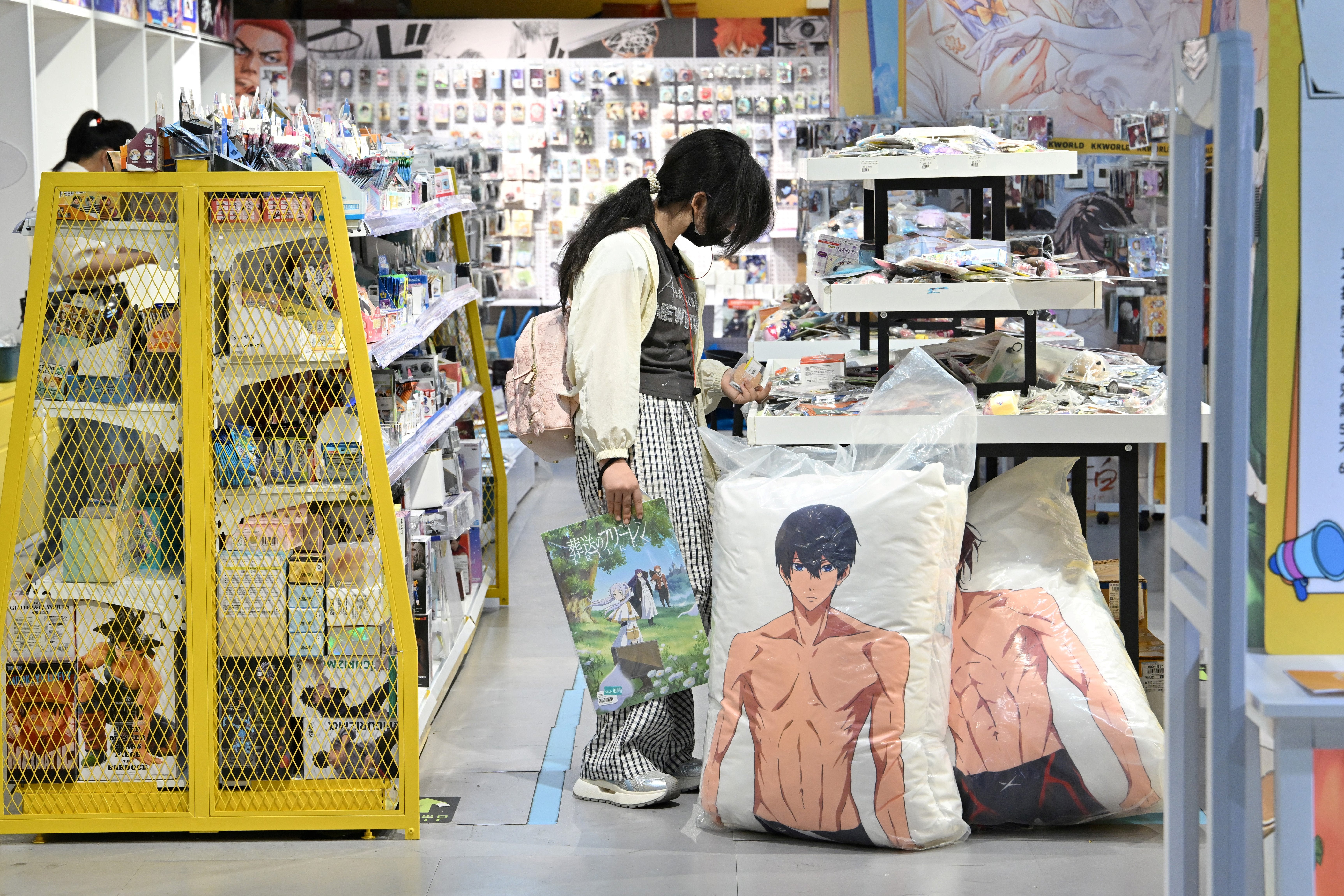 A woman visits a merchandise shop in Beijing on 9 July 2025 (AFP/Getty)