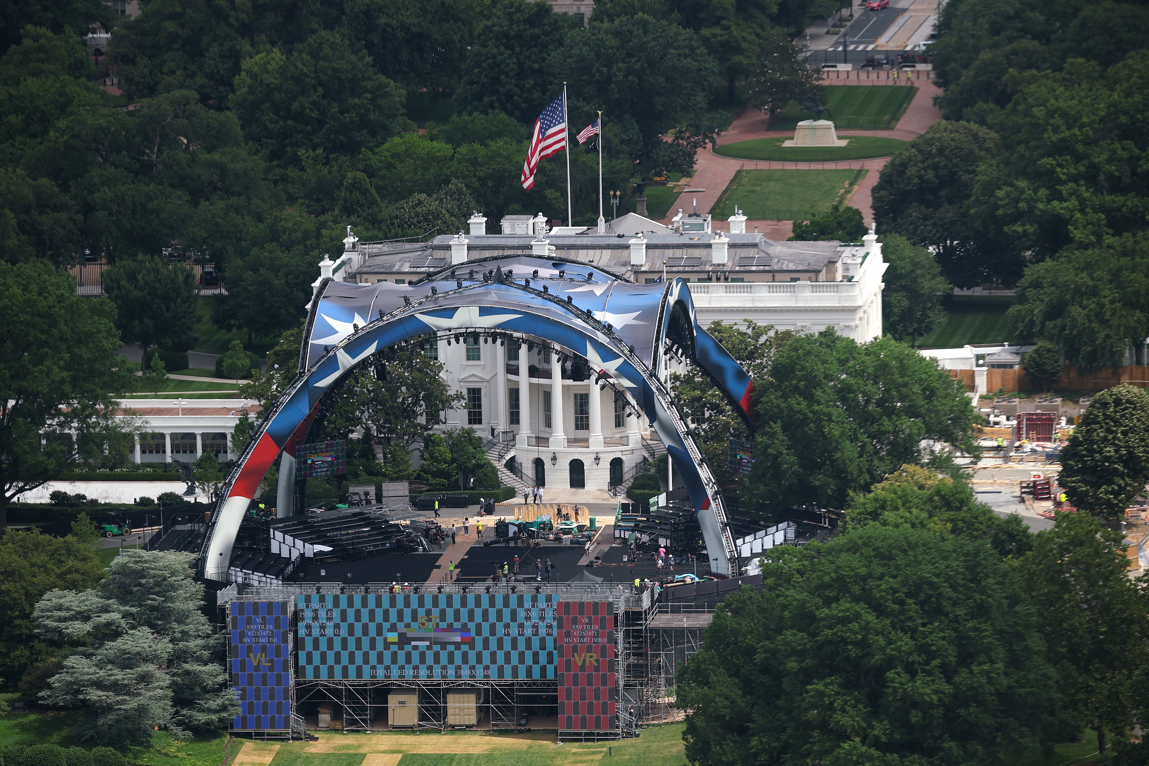 Workers build the outdoor UFC arena on the South Lawn of the White House which is expected to cost the parent company of the fighting organization $60 million to pull off
