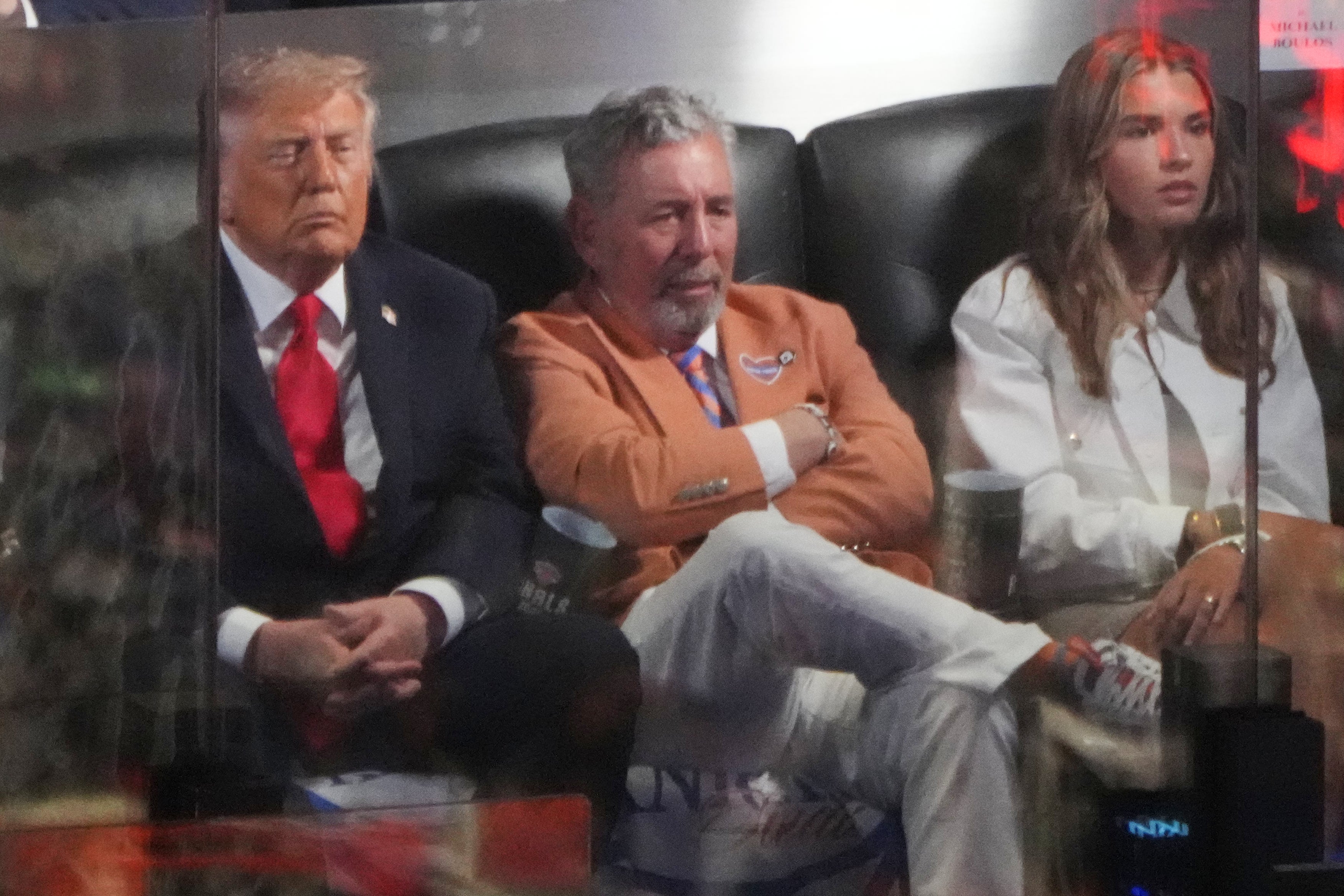President Donald Trump sits in a box at Madison Square Garden with Knicks owner James Dolan and his granddaughter, Kai Trump (AP Photo)