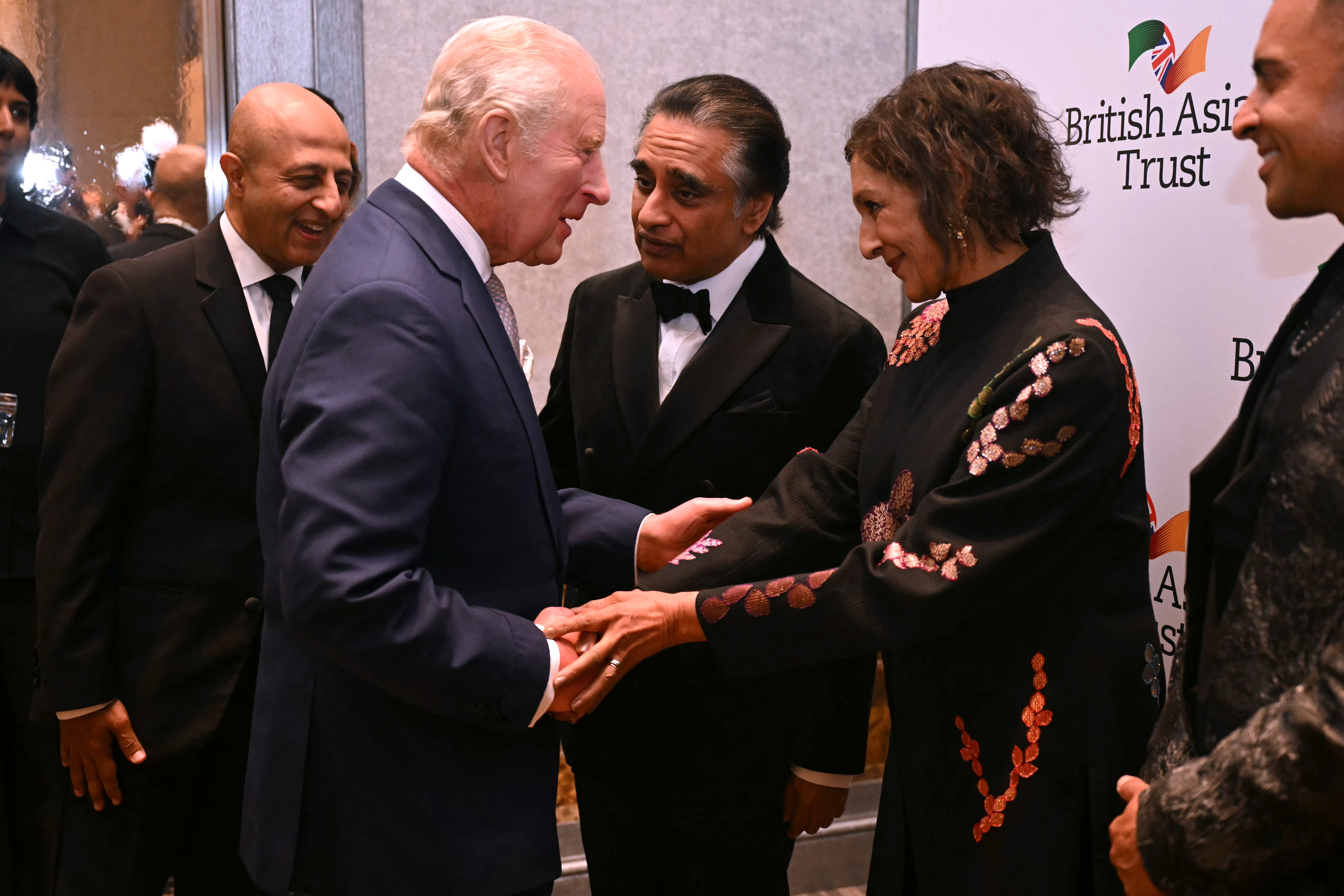 King Charles III (C) greets British comedian Dame Meera Syal (R) at a reception to celebrate the work of the British Asian Trust (Justin Tallis - WPA Pool/Getty Images)