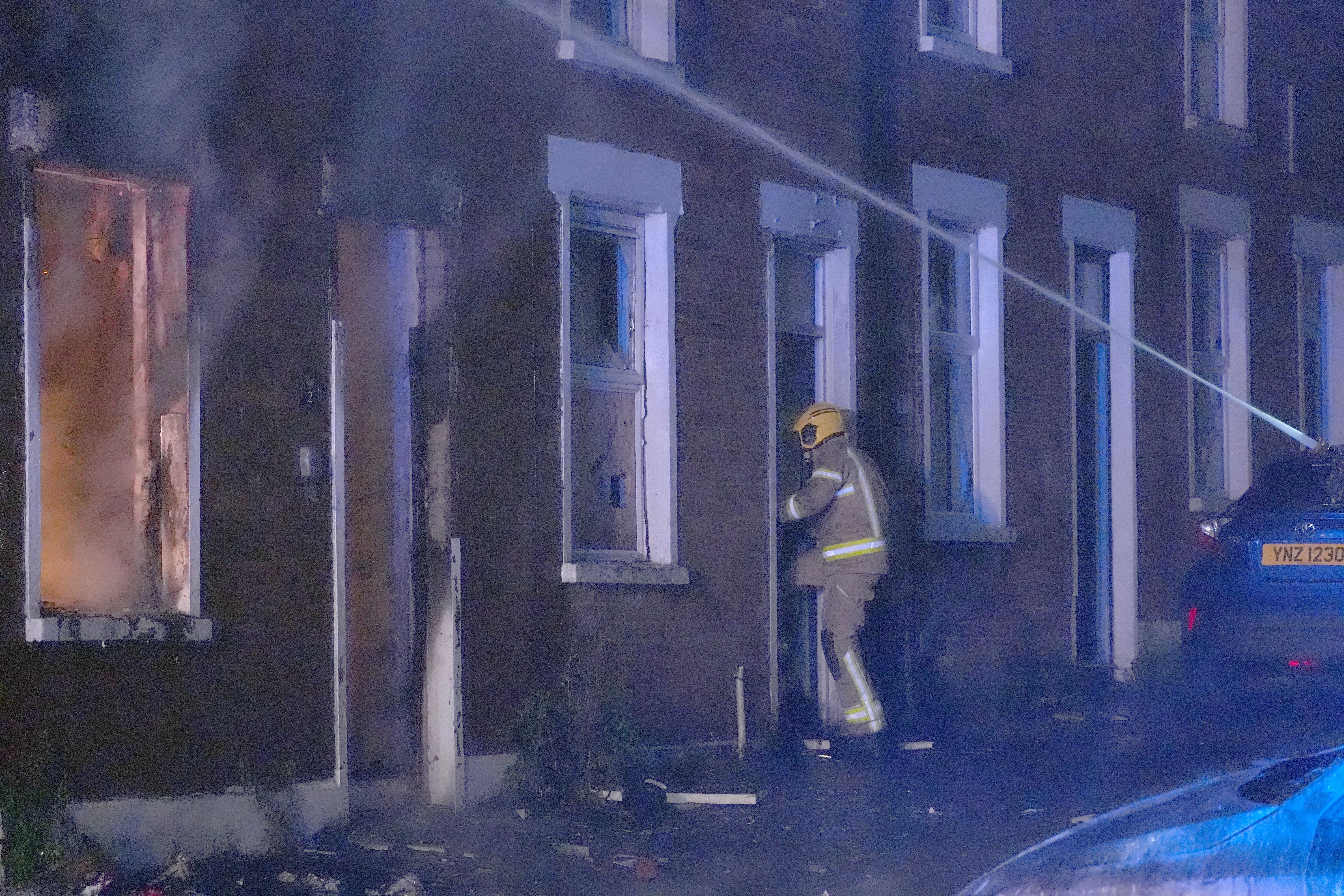 Firefighters attend a house which caught fire on Ligoniel Road (PA)