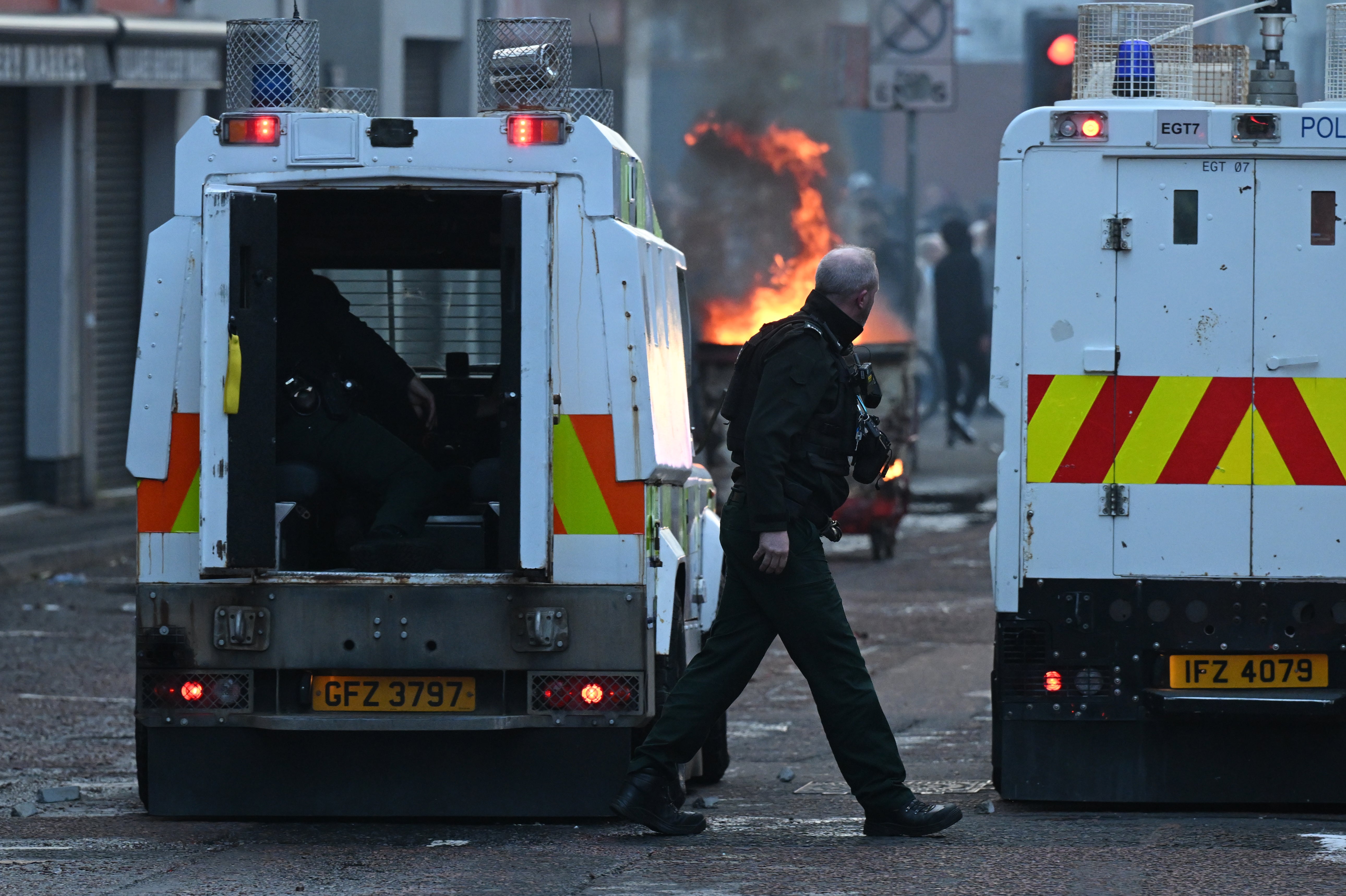 Police officers take cover from protestors on Sandy Row on June 9 (Getty)