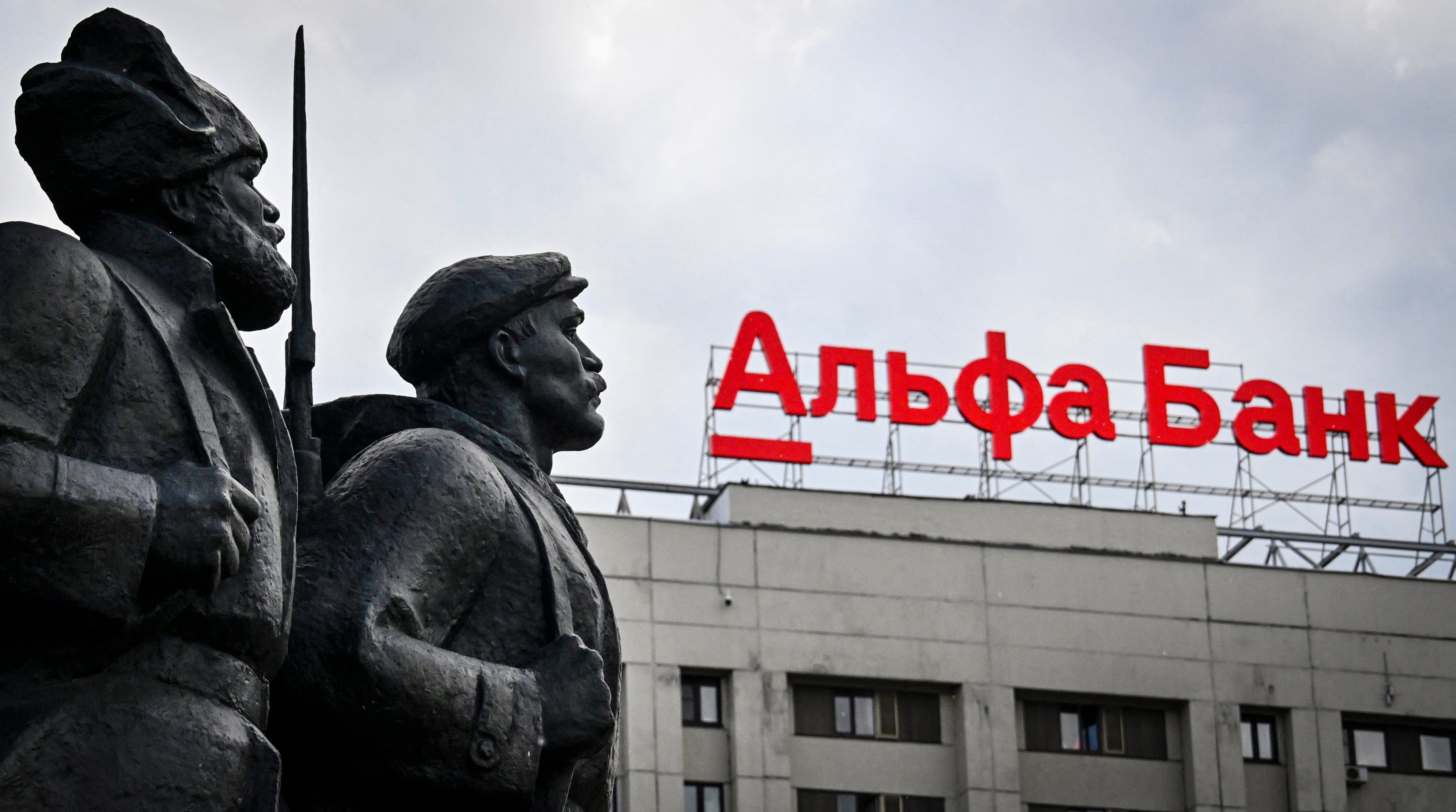 The logo of Alfa Bank, Russia's privately-held lender is seen atop of a building behind revolutionary militiamen in Moscow (AFP/Getty)