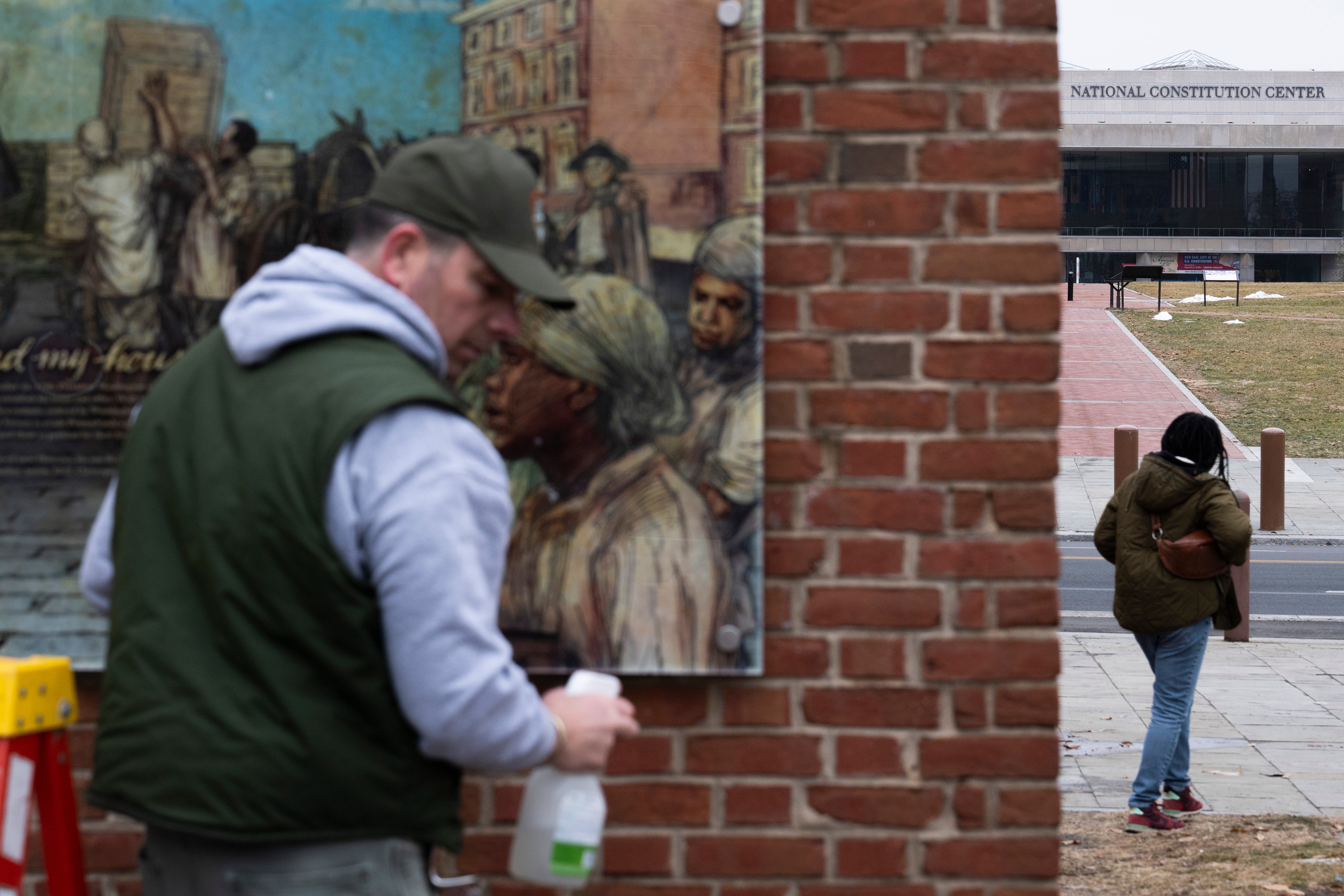 Panels that were part of an exhibit on slavery at the President's House Site in Independence National Historical Park are put back