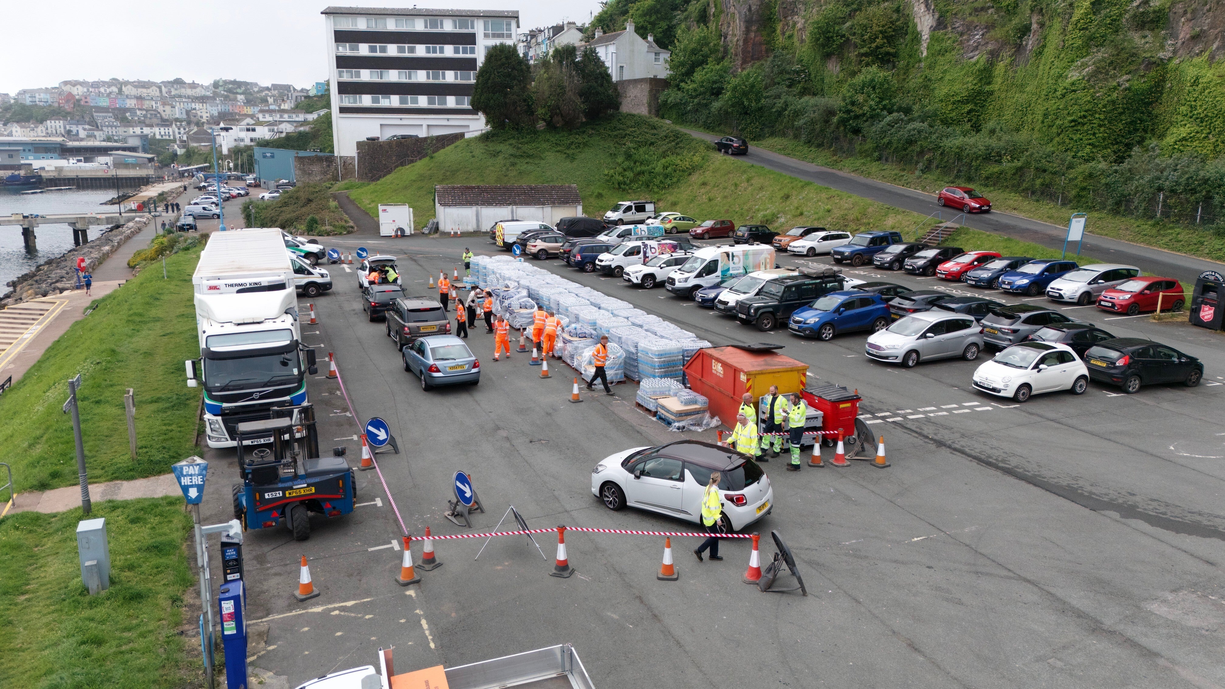 People collecting bottled water at Freshwater car park in Brixham in May 2024 (Ben Birchall/PA)