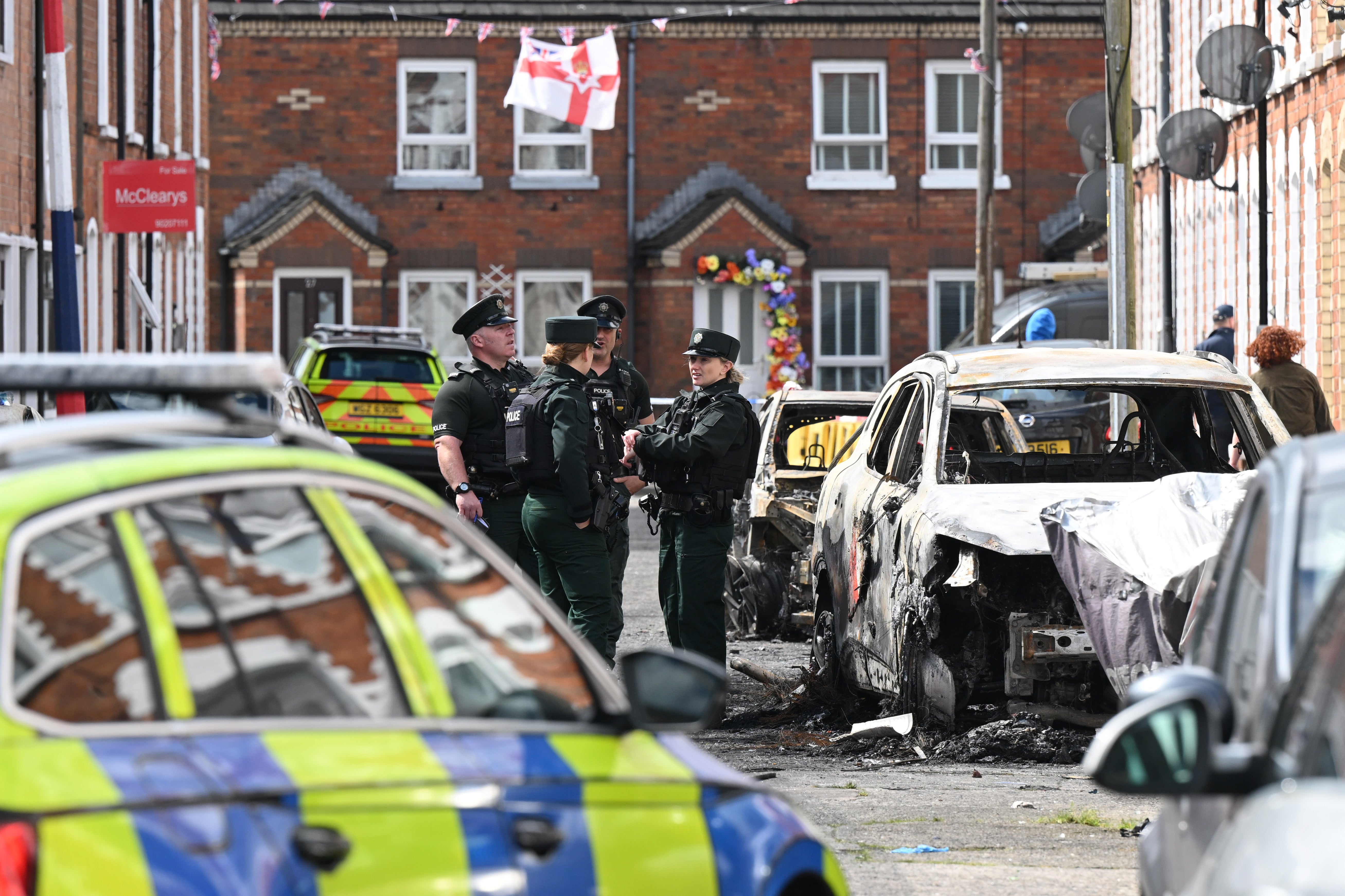 Police attend the scene as residents begin to clean-up on Lendrick Street