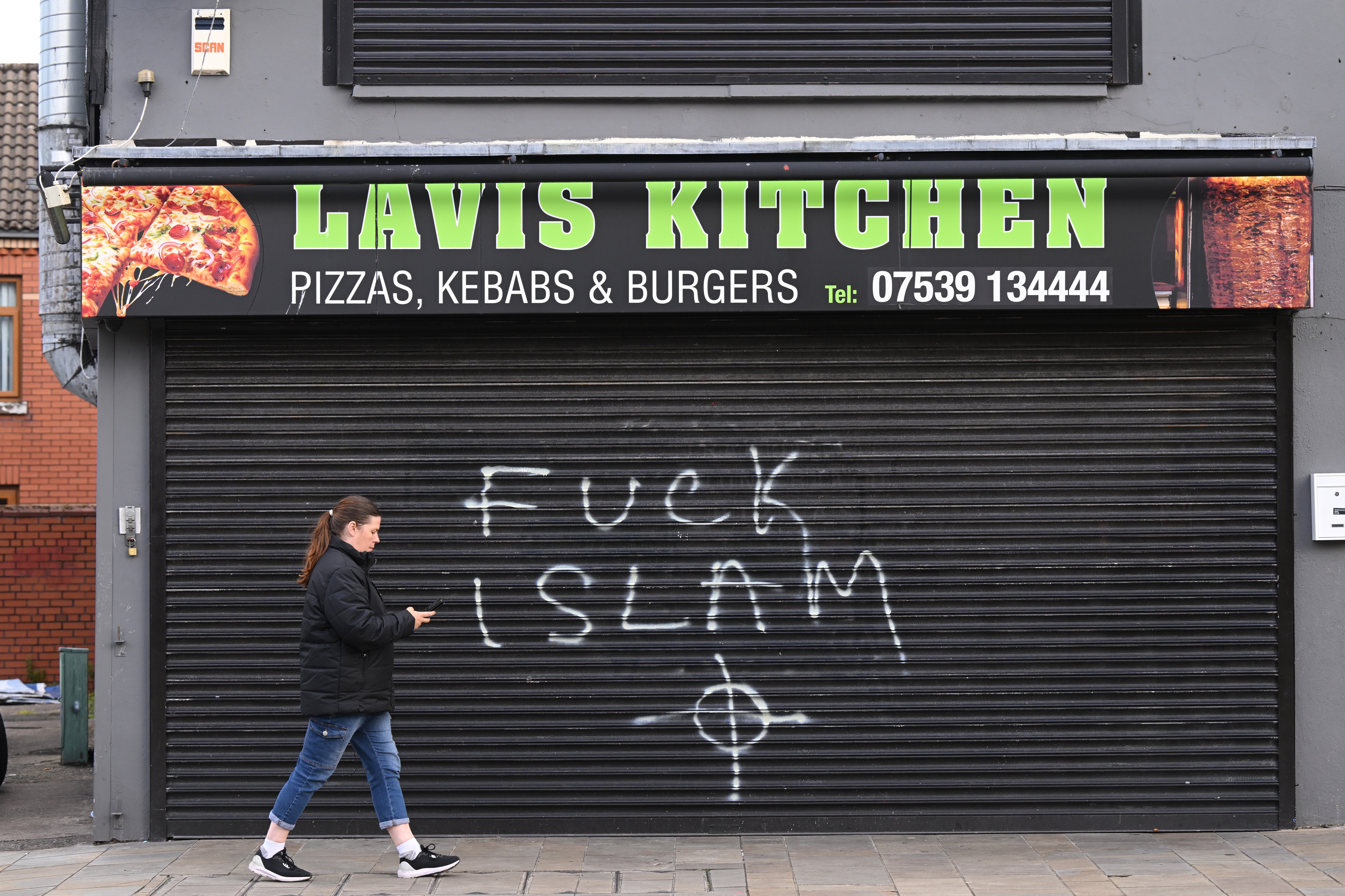 Anti-Islam graffiti on a kebab shop in Newtownards Road following a night of anti-immigrant riots (Getty)