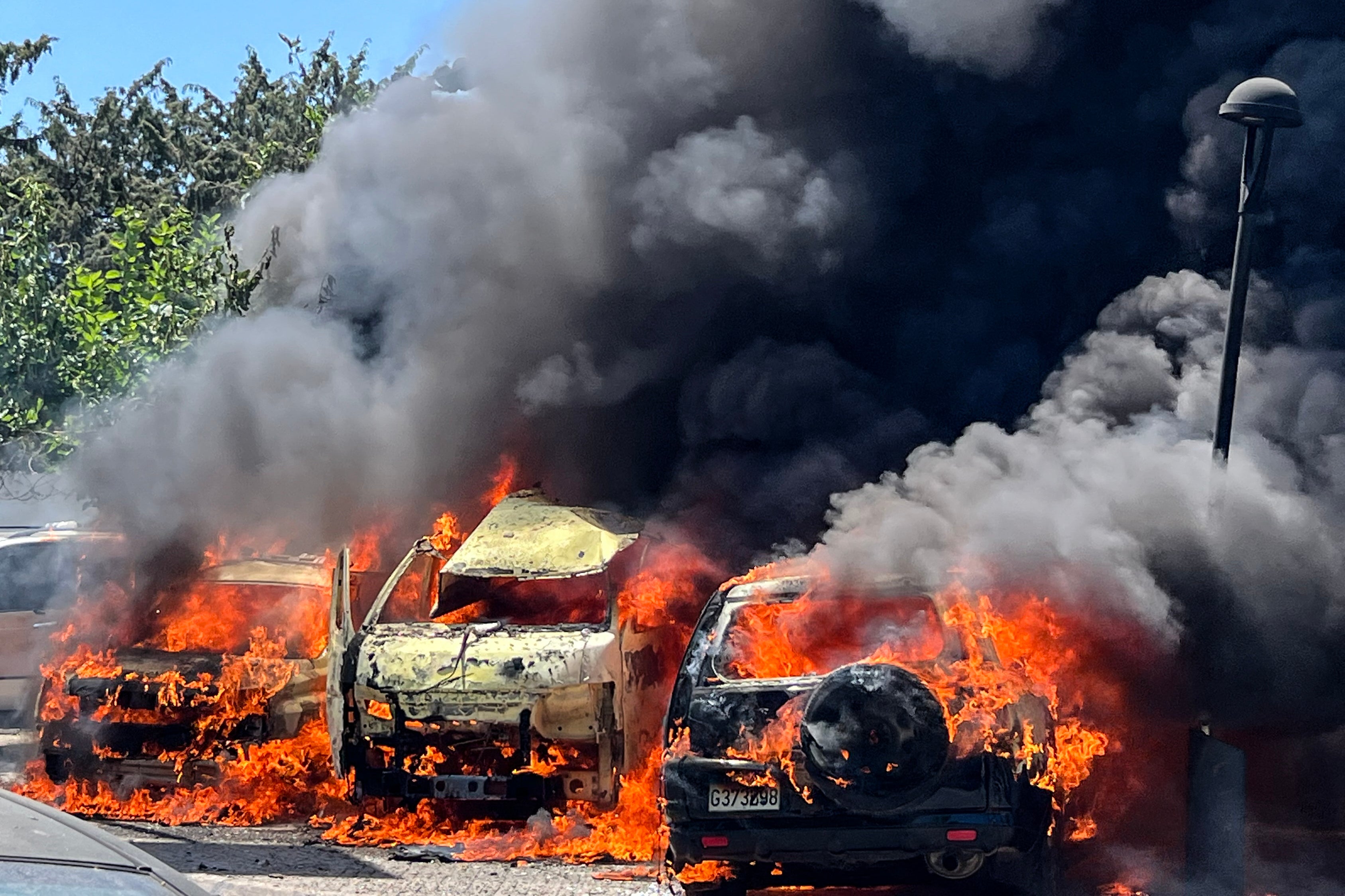 Flames engulf vehicles following an Israeli airstrike that hit a car in Sidon (AFP/Getty)