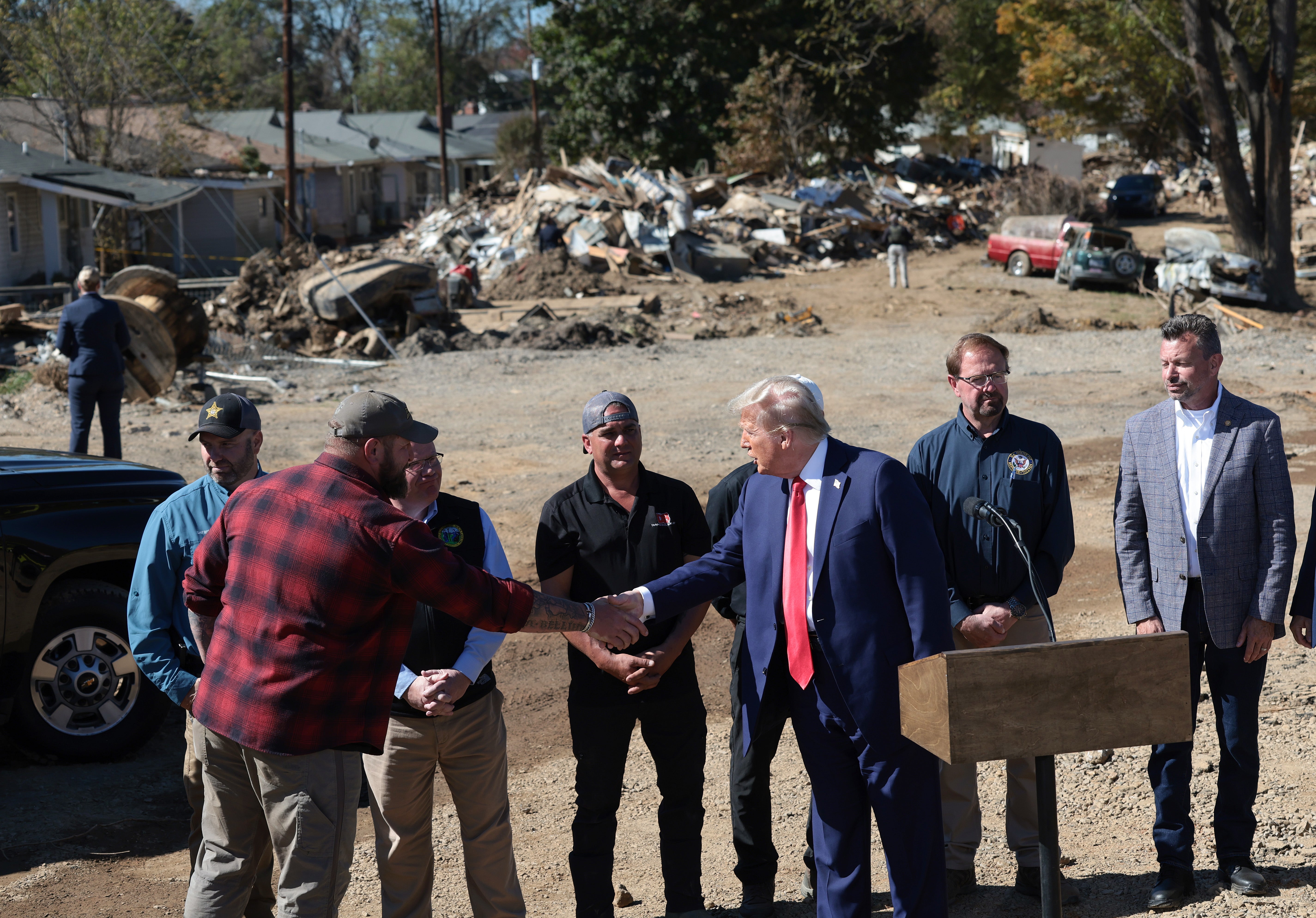 In the past, Trump has called for FEMA to be radically overhauled or dismantled. Pictured: Trump visits with local officials and residents affected by Hurricane Helene in 2014