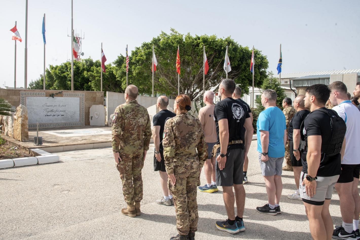 Unifil peacekeepers at Shamaa base stand at attention following a fitness test in memory of their comrades killed since 2 March 2026.