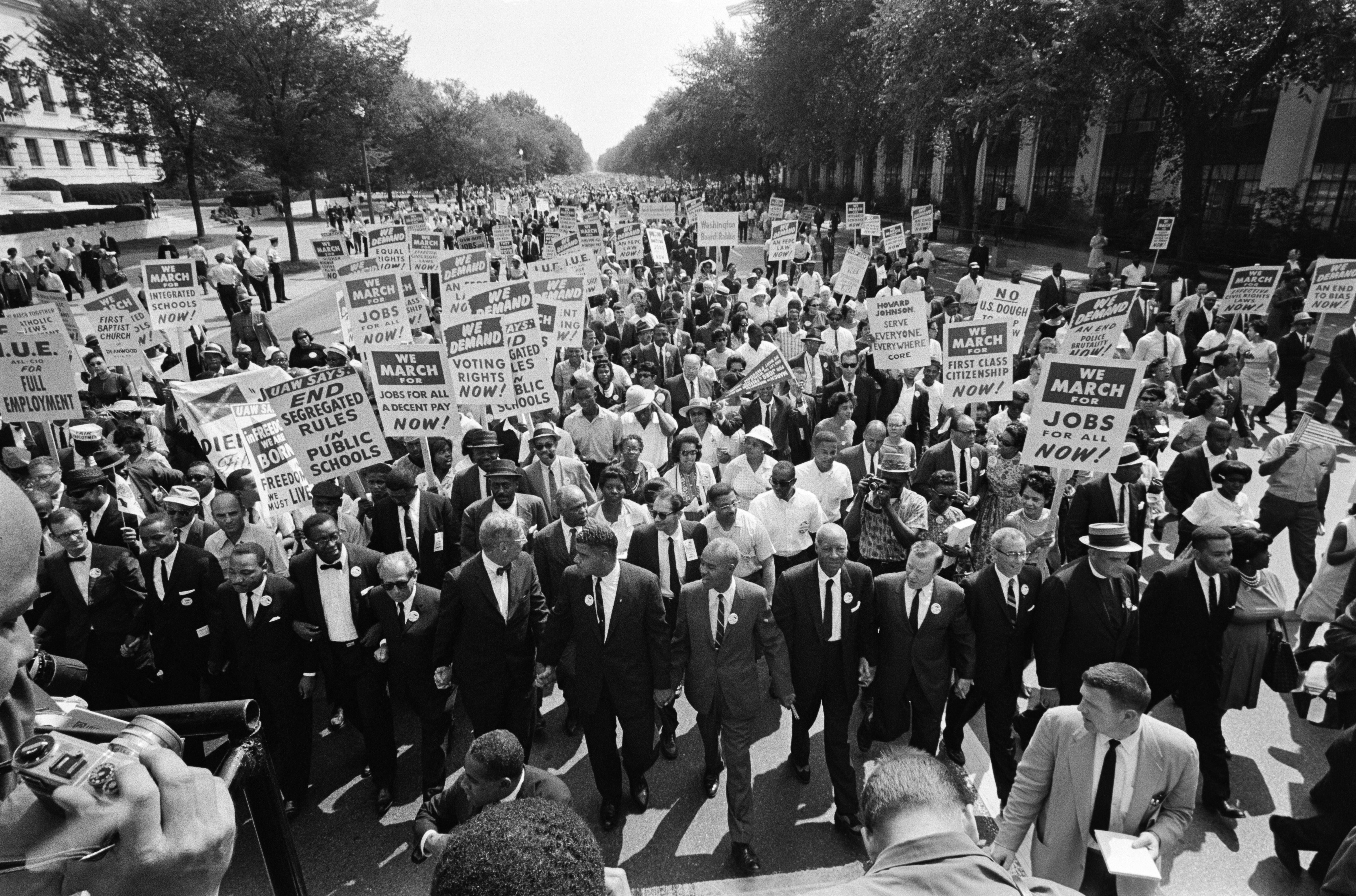 The Rev. Martin Luther King Jr. (3rd L) and other black and white civil rights leaders lead the 