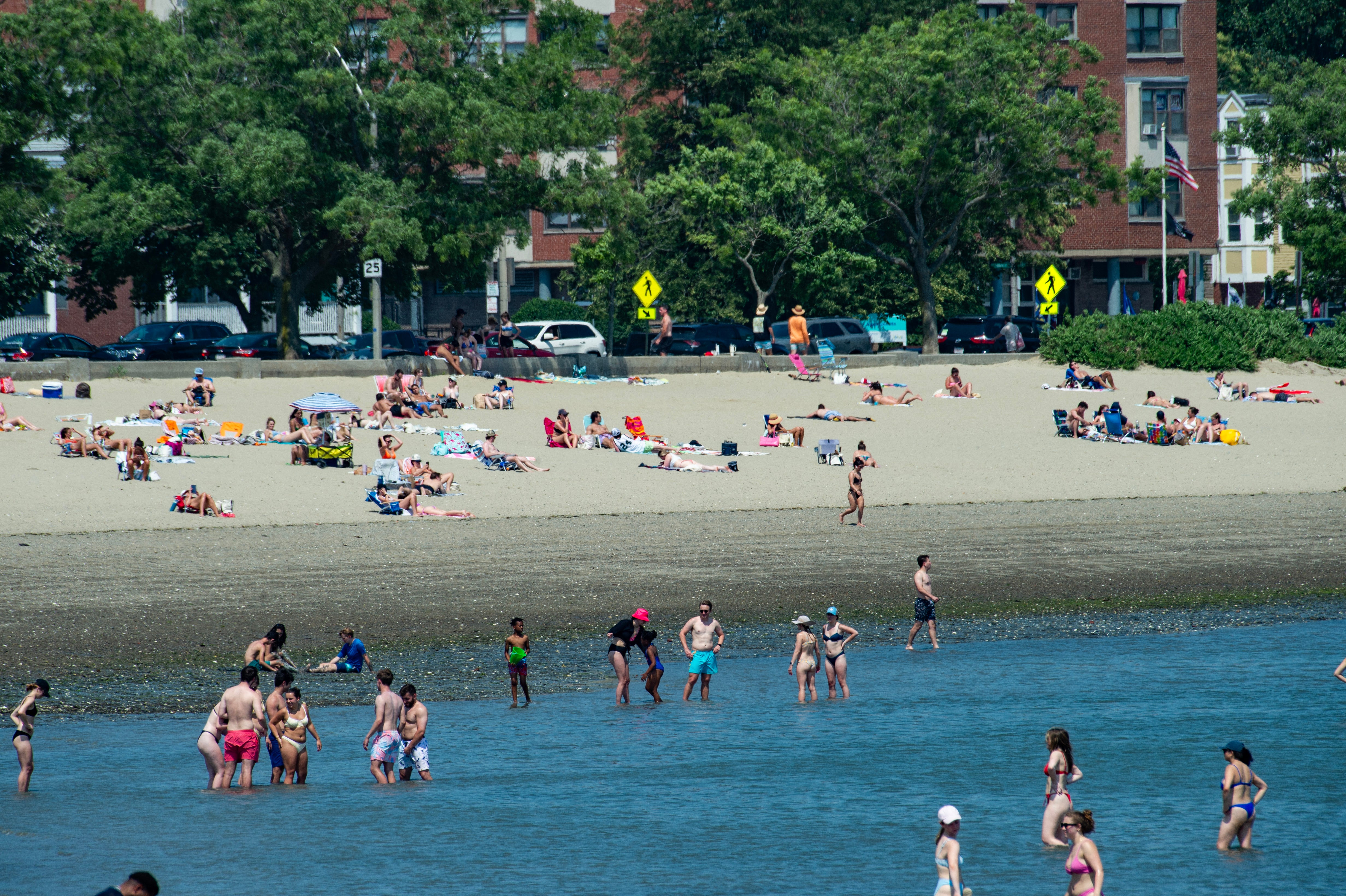 Visitors enjoy a summer day at Carson Beach in Boston, which can be reached using the city’s T Red Line