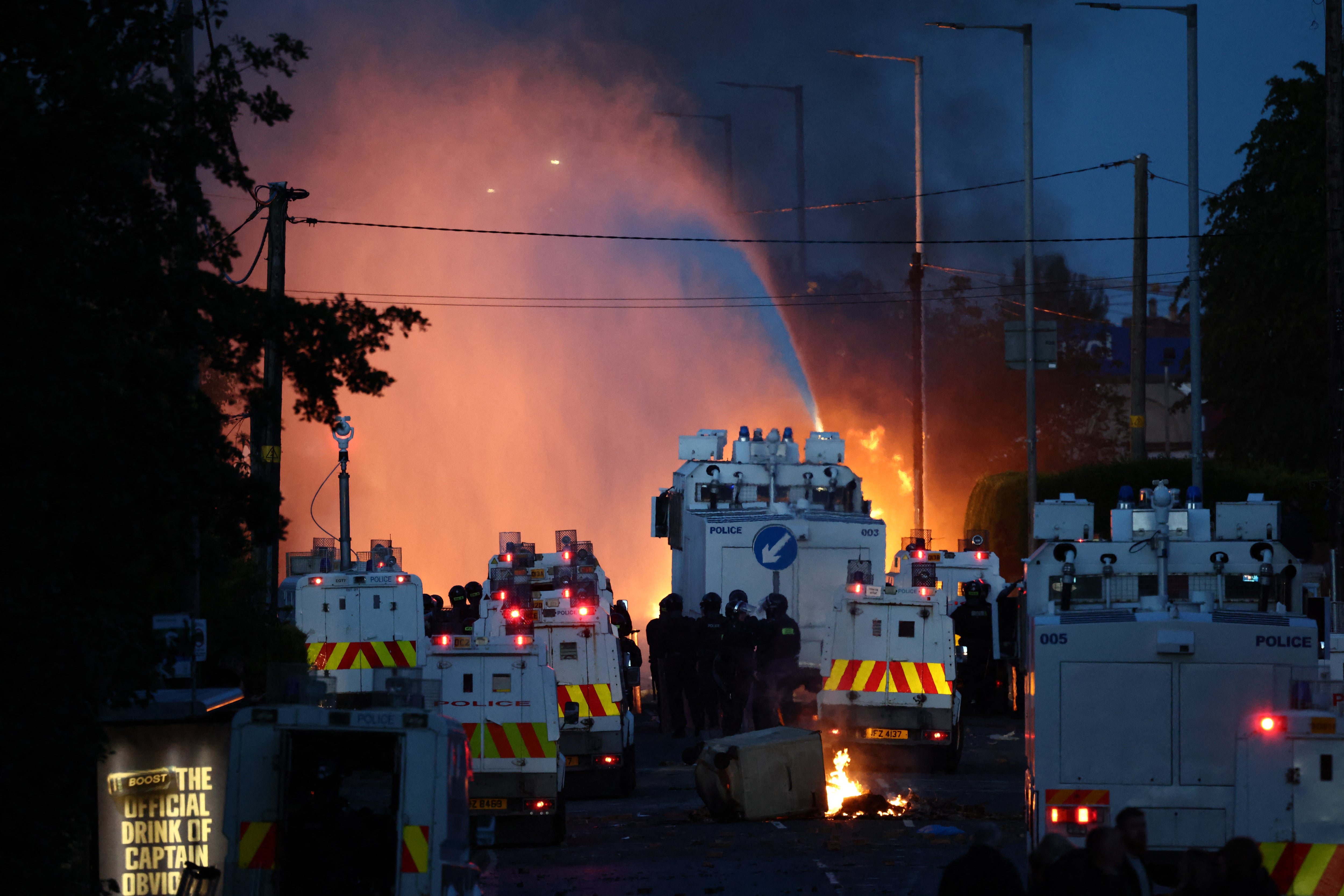 Police use a water cannon as they block the road from protesters (AFP/Getty)