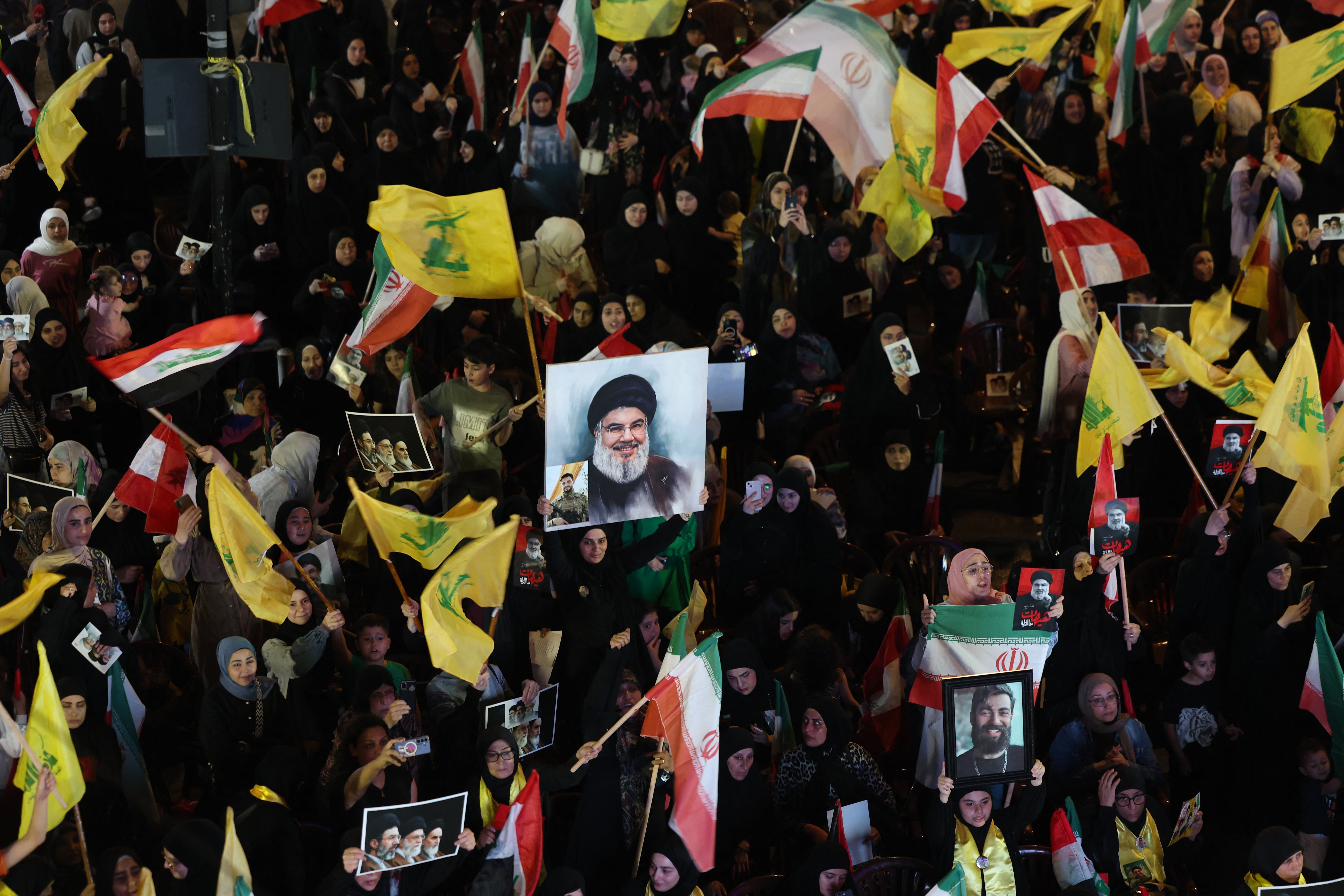 Supporters of Iran-backed armed group Hezbollah, wave flags and hold a portrait of slain leader Hassan Nasrallah during an anti-US and anti-Israel protest organised by the International Popular Committees to Resist Aggression in Beirut's southern suburbs on June 10, 2026 (AFP/Getty)
