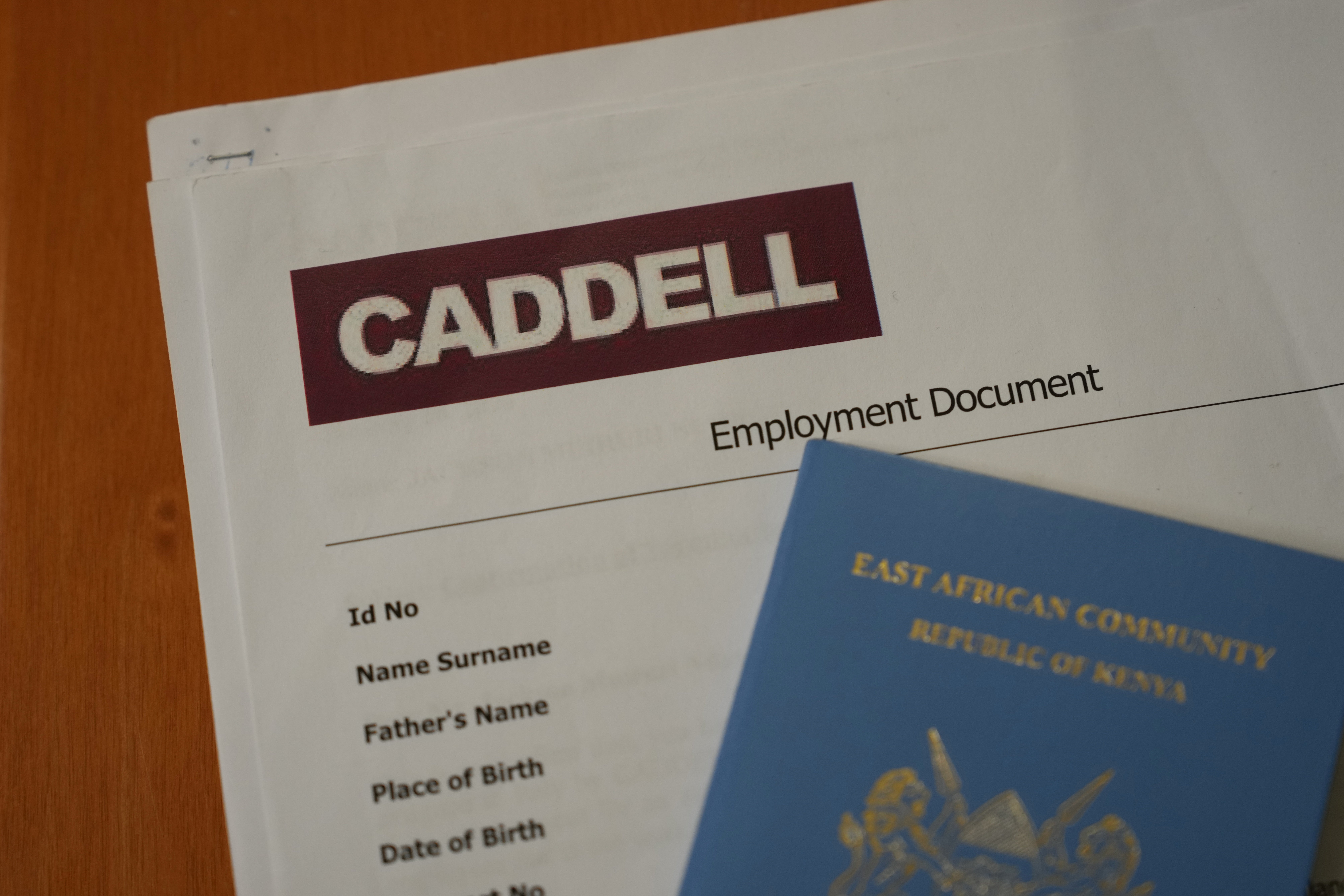 Employment documents and a passport belonging to a worker at the construction site of the new U.S. Consulate