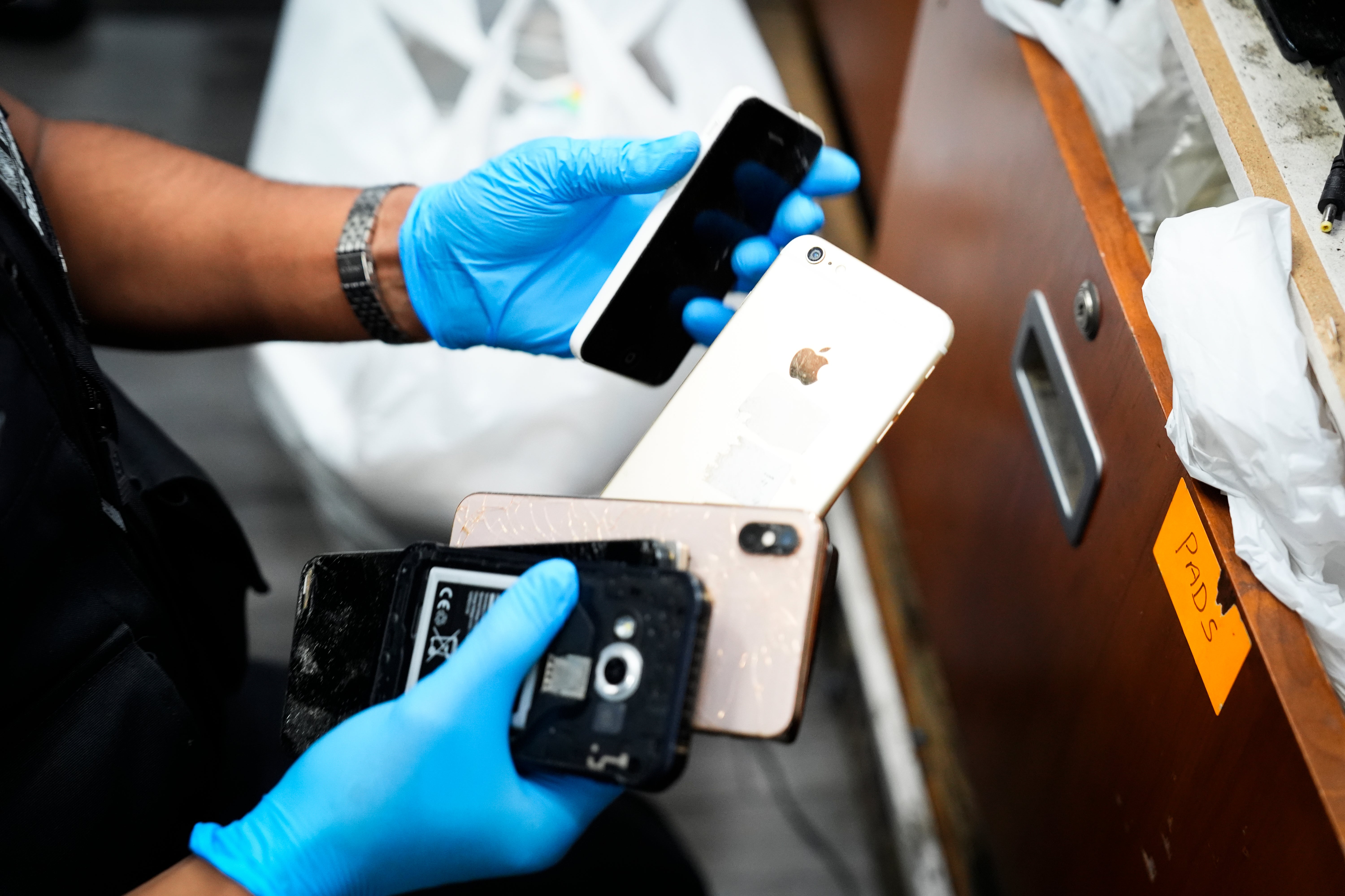 Officers execute search warrants at shops suspected of handling stolen devices in Holloway, north London