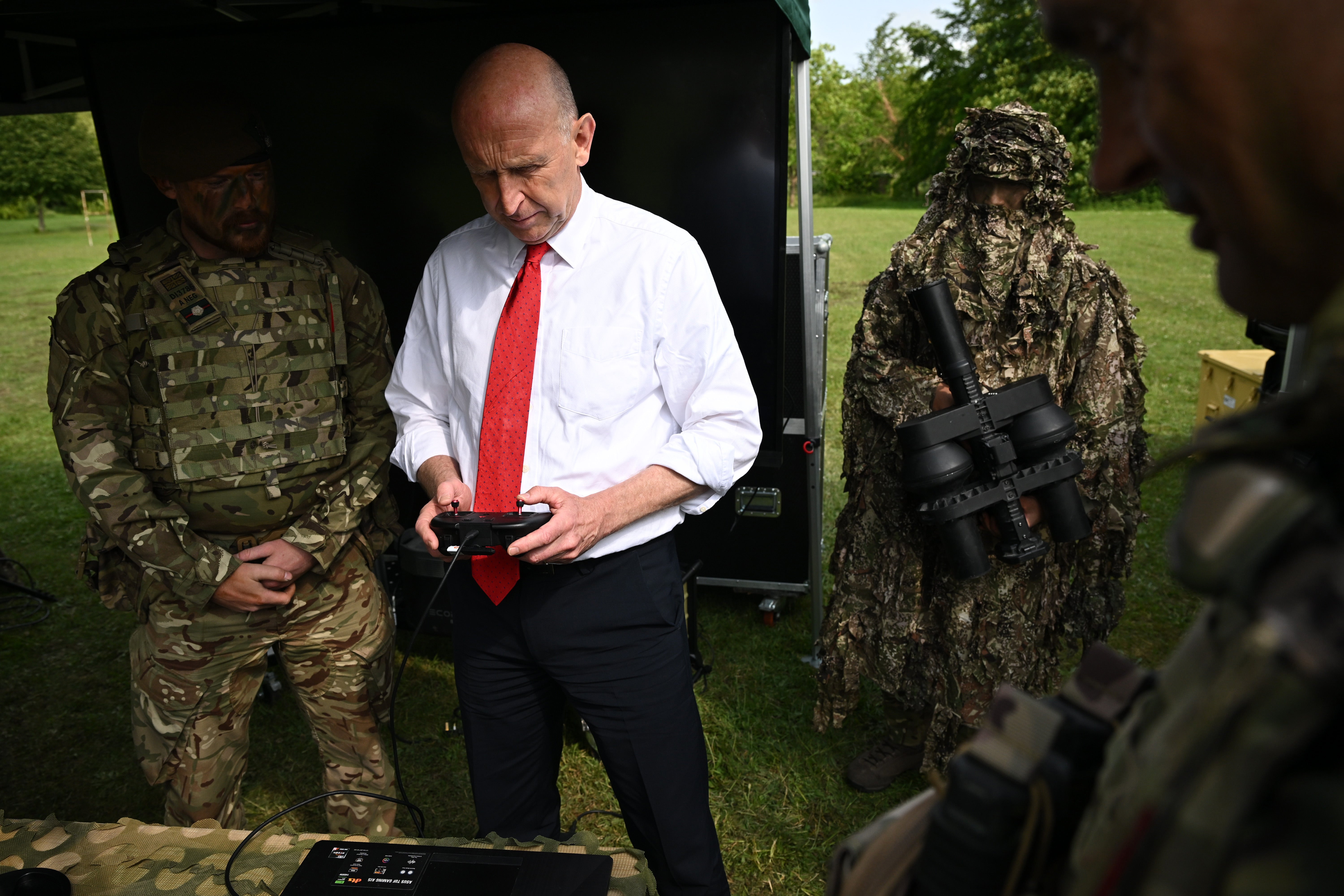John Healey uses a controller to try an FPV drone training system in 2025