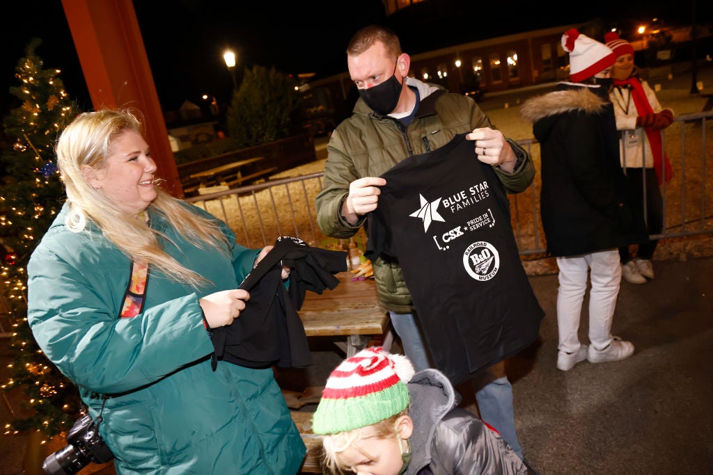 Young guests receive their gifts at a 2021 Christmas event in Baltimore, Maryland, sponsored by the History Channel and Blue Star Families. Blue Star is one of several charities that Craigslist founder Craig Newmark, whose father served in the military, donates to