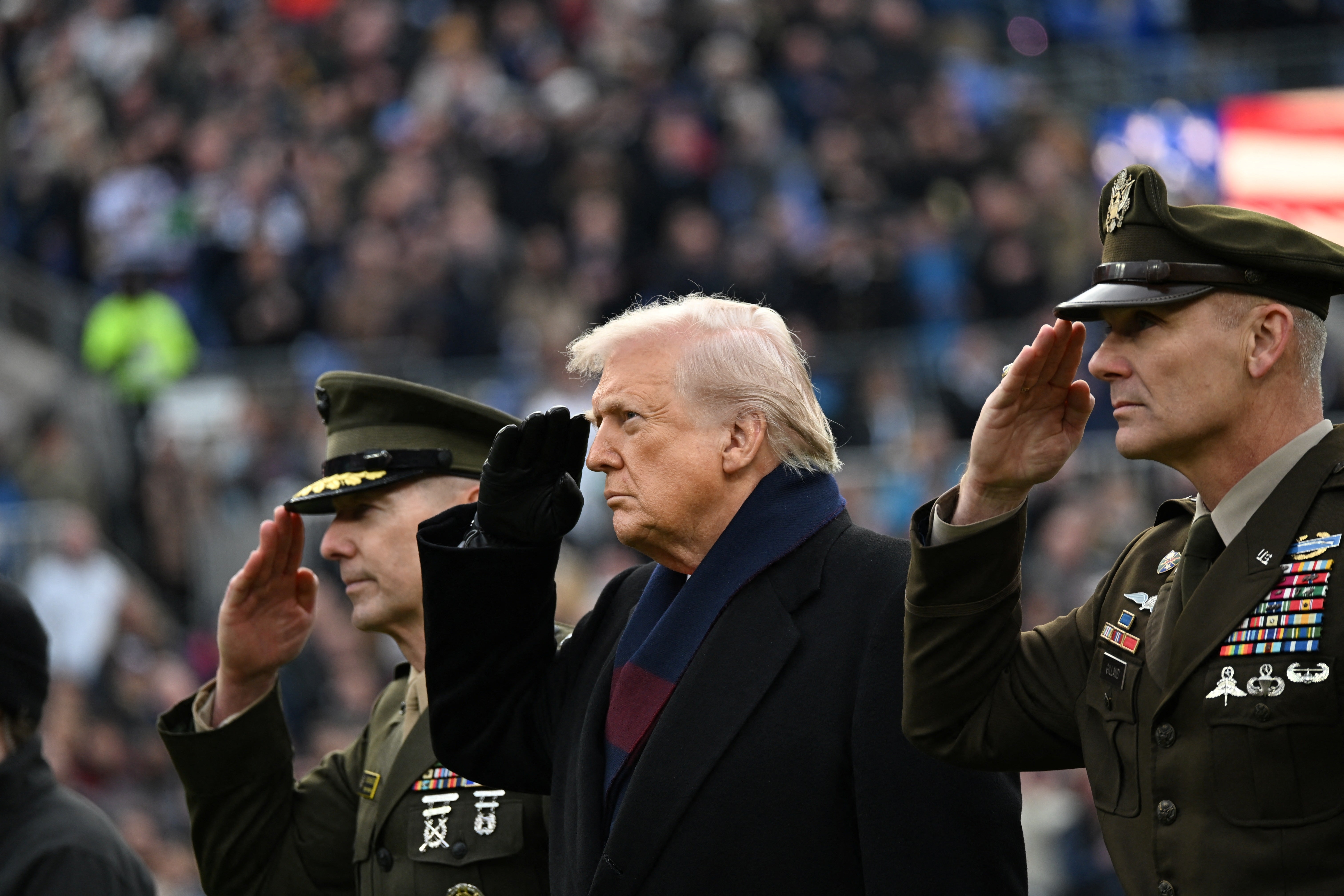 Donald Trump salutes before the college football game between the US Army and Navy at the M&T Bank Stadium in Baltimore last December