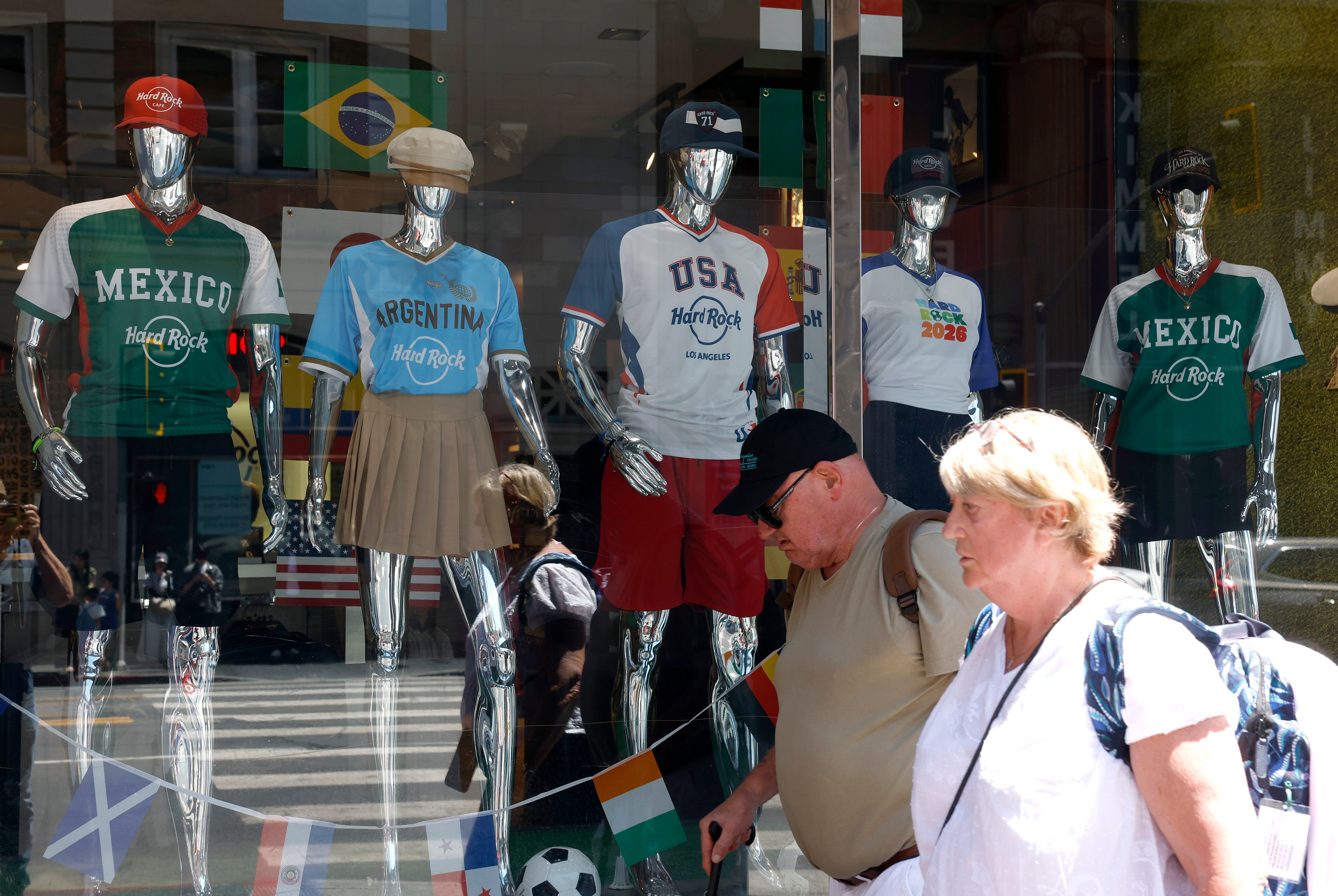 A pair of Americans walk past a display of World Cup jerseys in Santa Monica, California. More than 4 in 10 Americans said in a recent survey that they were not interested in the 2026 World Cup