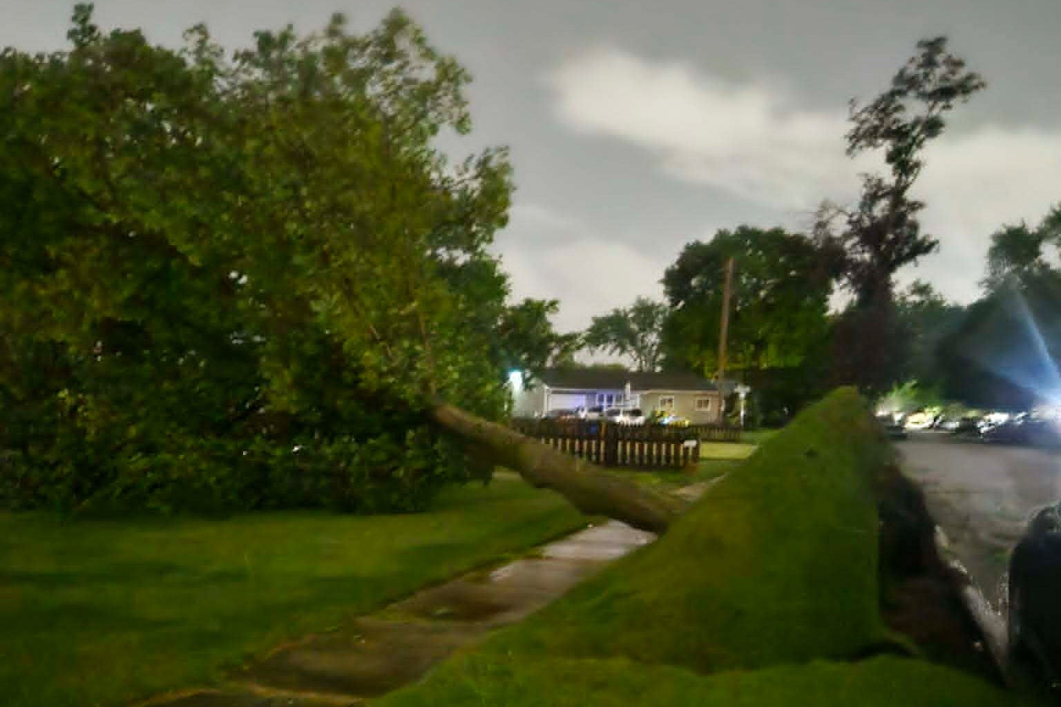 Jennifer Hall was in her garage in Elkhart, Indiana, as the winds and rain picked up Thursday evening. Suddenly, she said, she heard a loud crash and discovered a tree limb had gone through the roof of her rental home (AP)