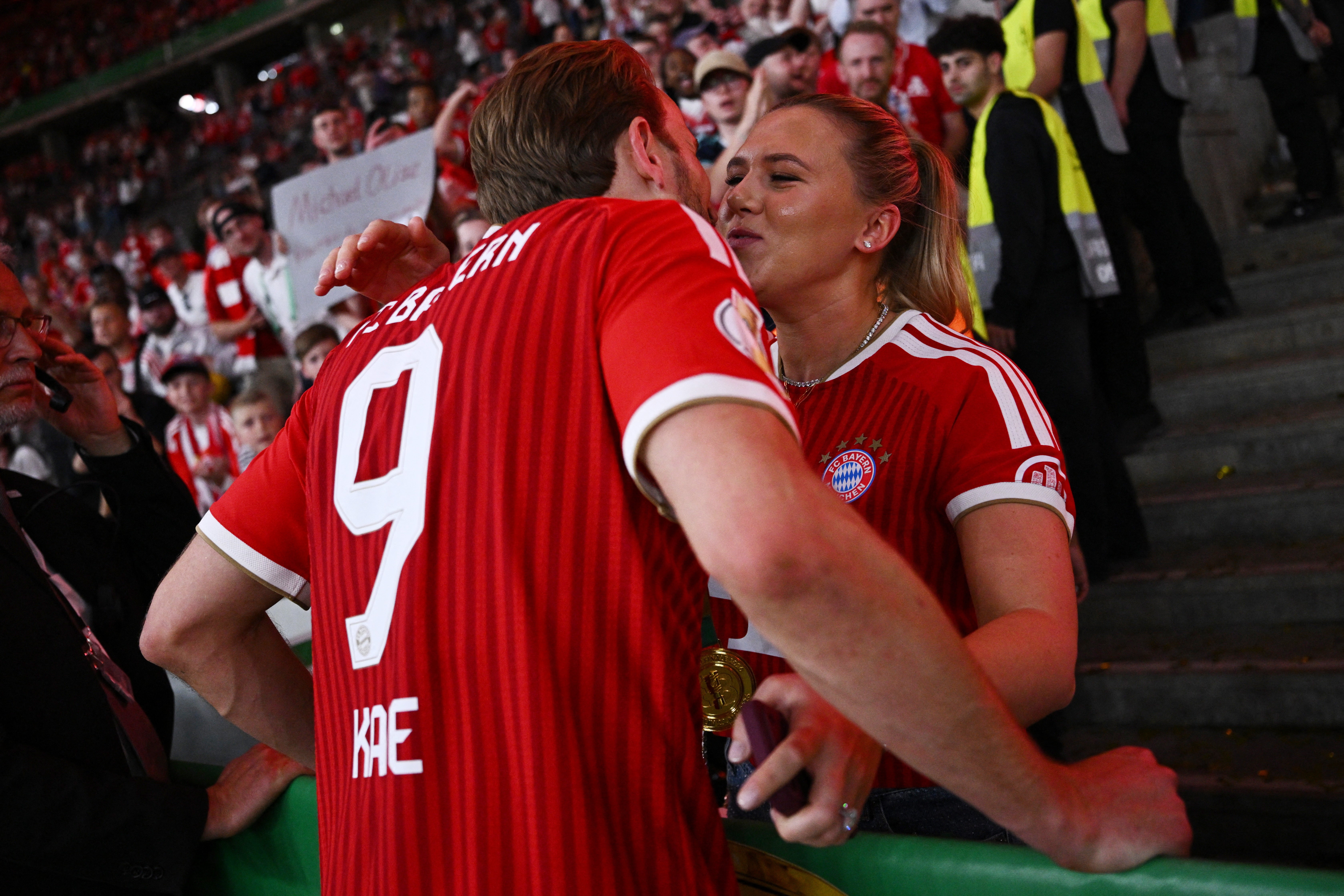Bayern Munich's Harry Kane celebrates with his wife Katie Goodland after winning the German Cup (Reuters)