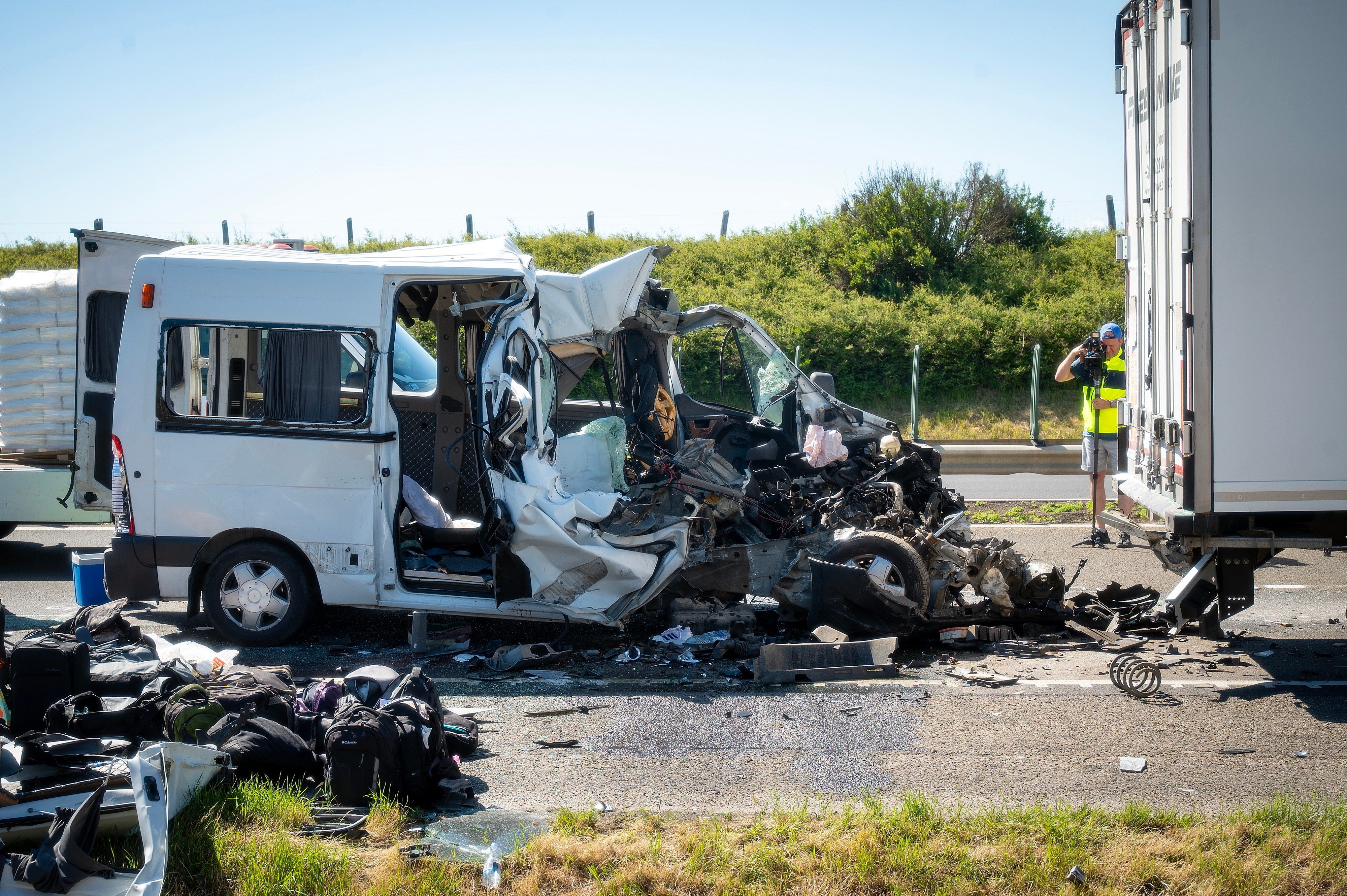 A damaged minibus is seen on the M1 motorway near Gyor, Hungary