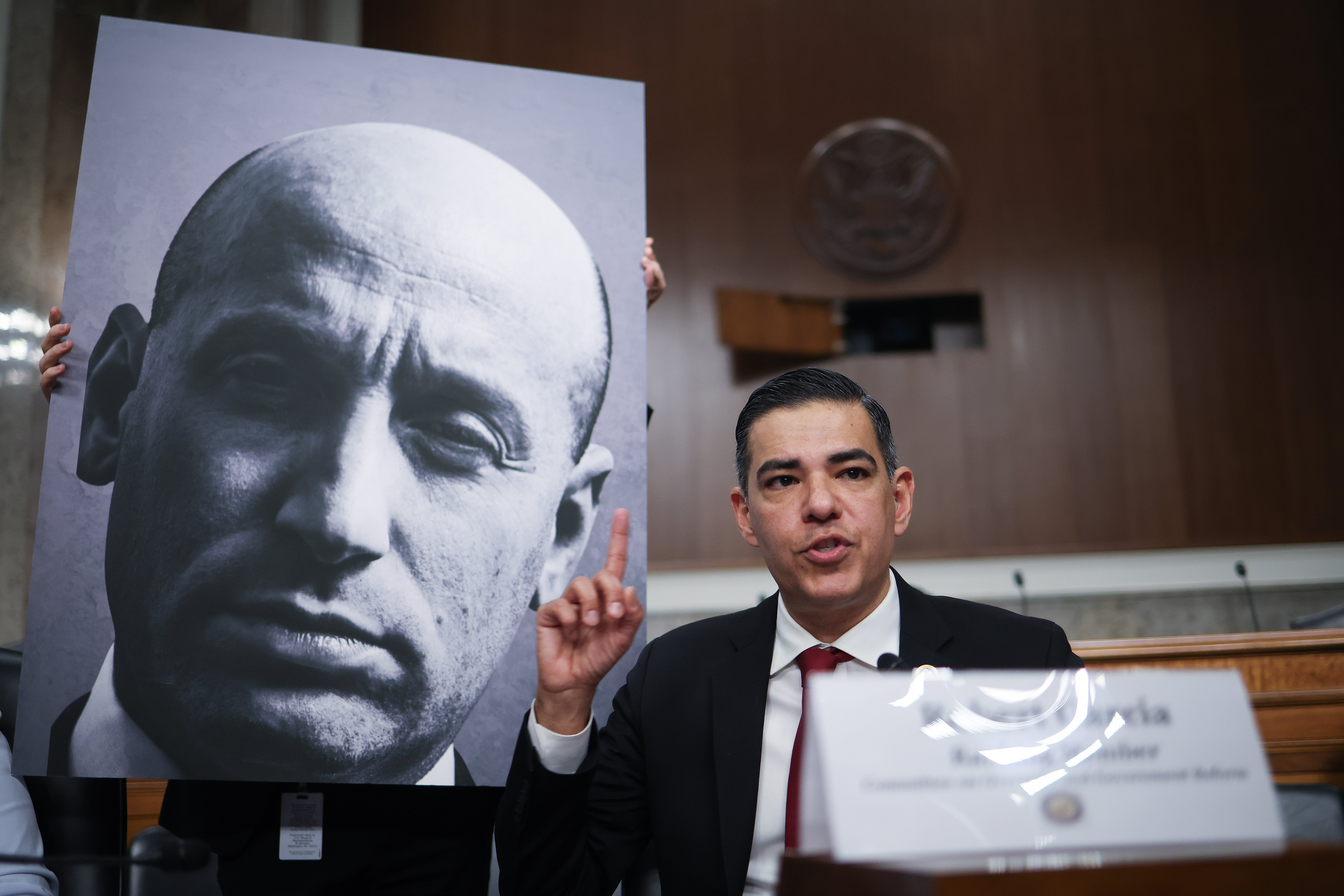 Rep. Robert Garcia (D-CA) speaks while referencing a photo of Deputy White House Chief of Staff Stephen Miller during a public forum on violent use of force by Department of Homeland Security (DHS) agents