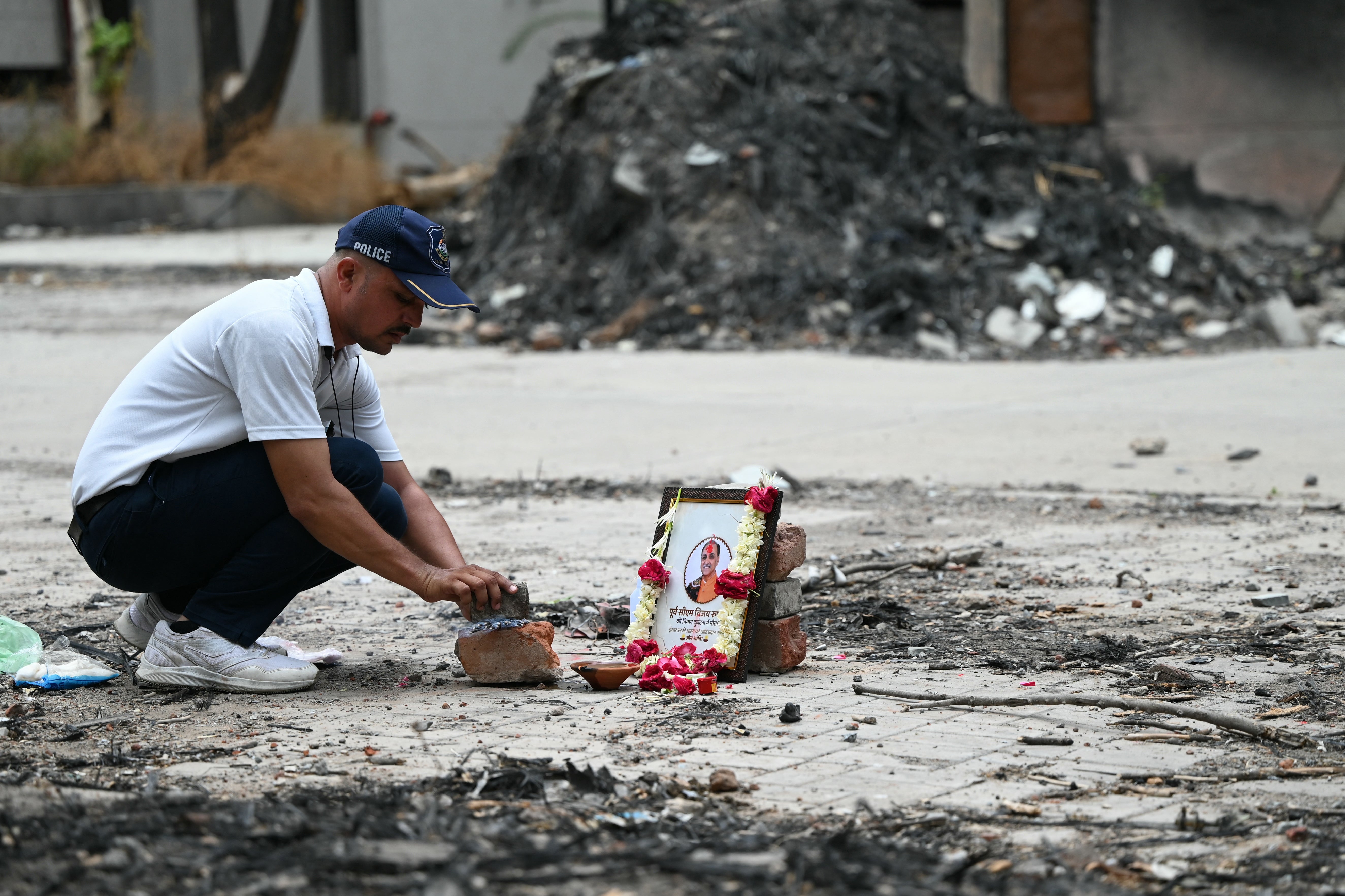 A tribute is set up for Air India Flight 171 plane crash victim Vijay Rupani, former Gujarat chief minister, at the crash site on the first anniversary of the disaster in Ahmedabad