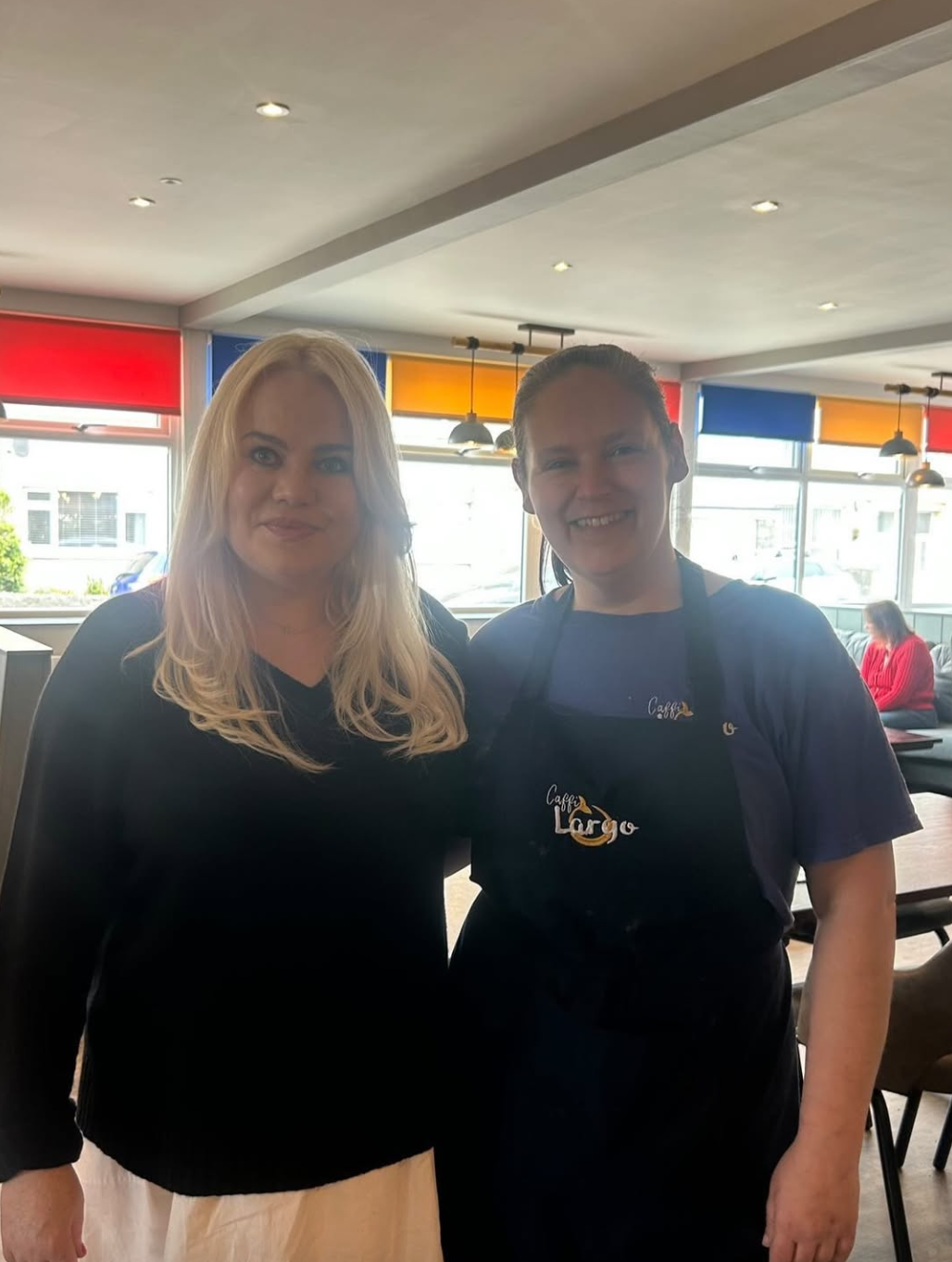 Duffy posing with a staff member at the cafe