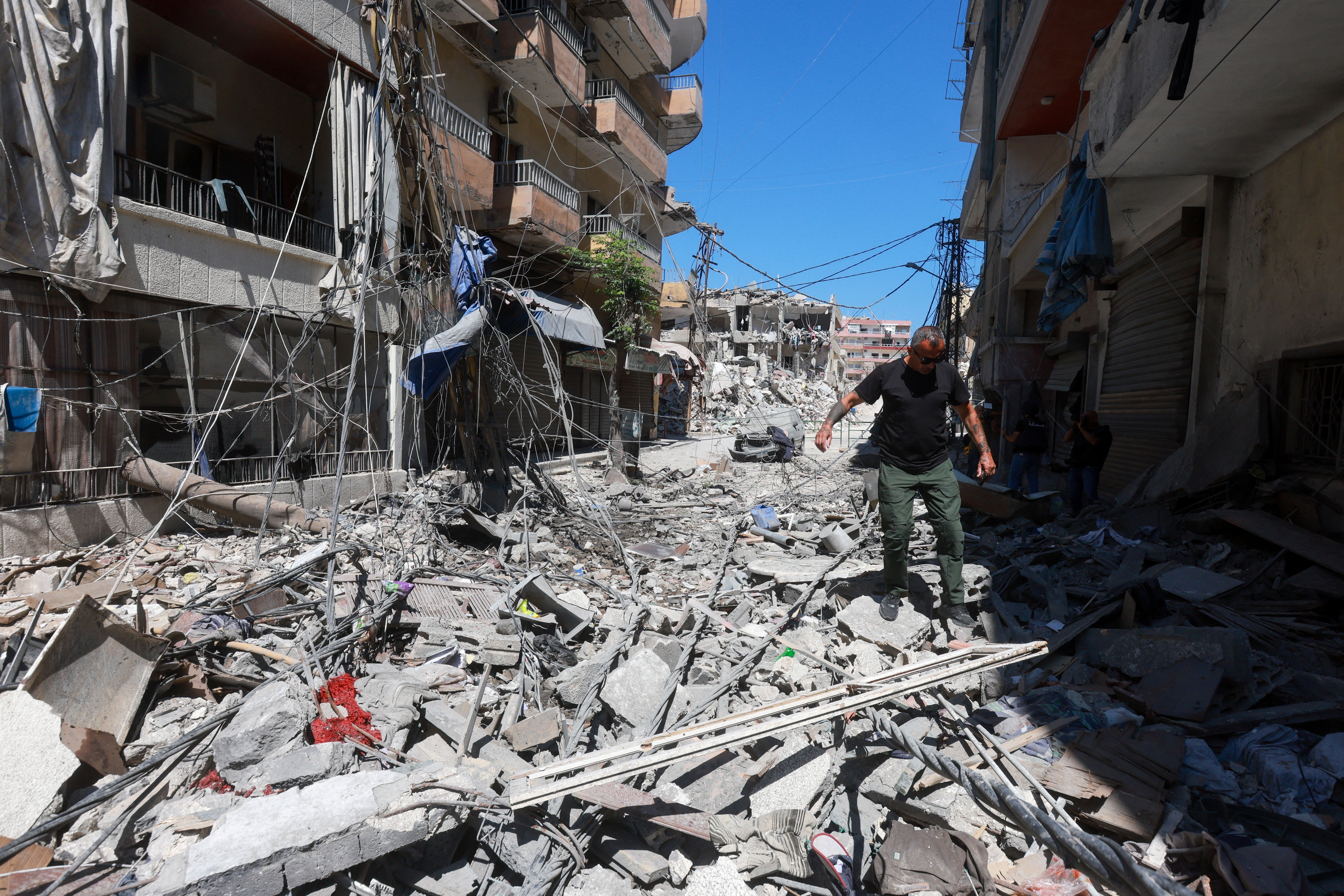 A man walks on rubble at the site an Israeli strike in Tyre, Lebanon