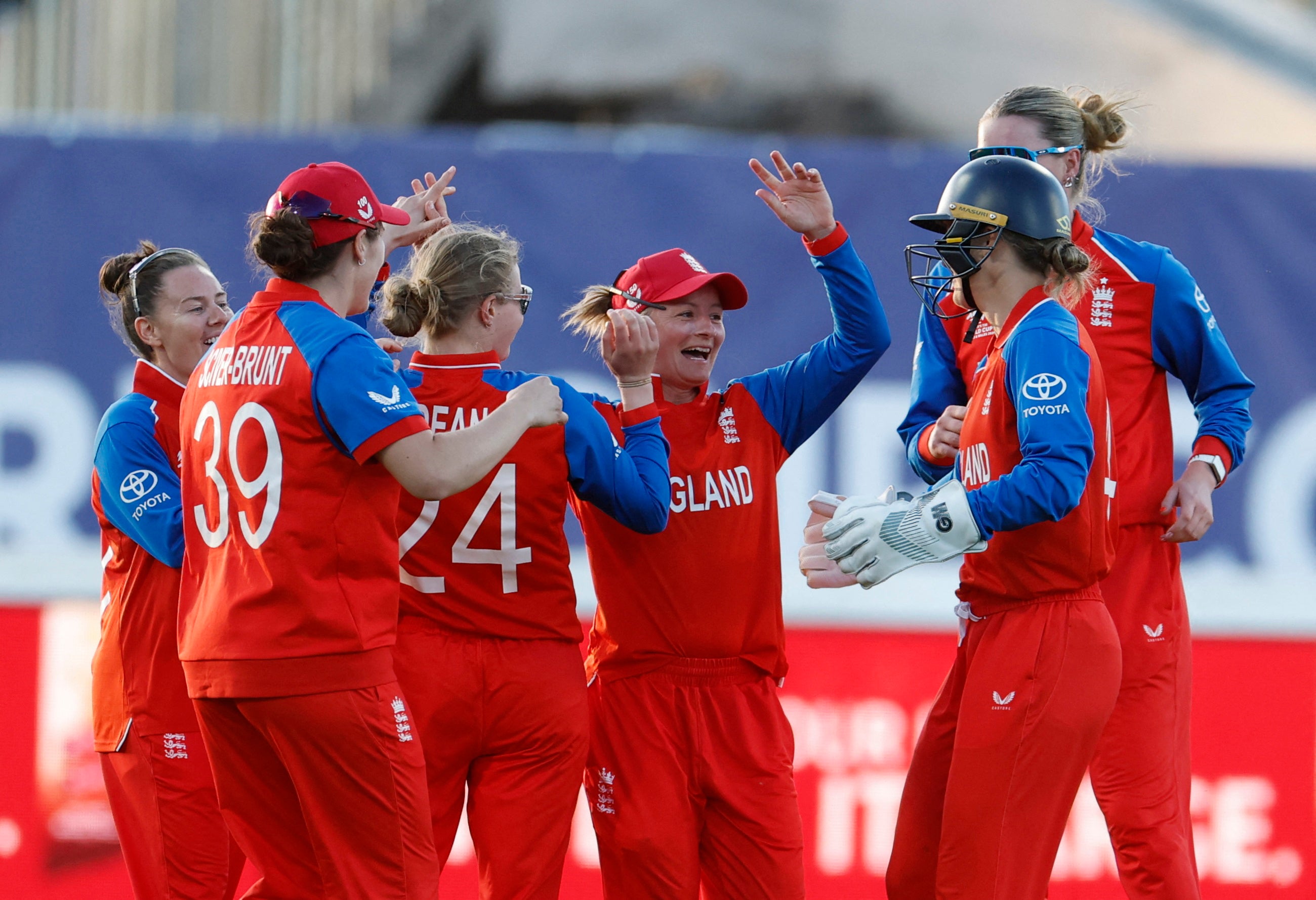 England's Danni Wyatt-Hodge celebrates with teammates after taking a catch to dismiss Chamari Athapaththu off the bowling of Charlie Dean