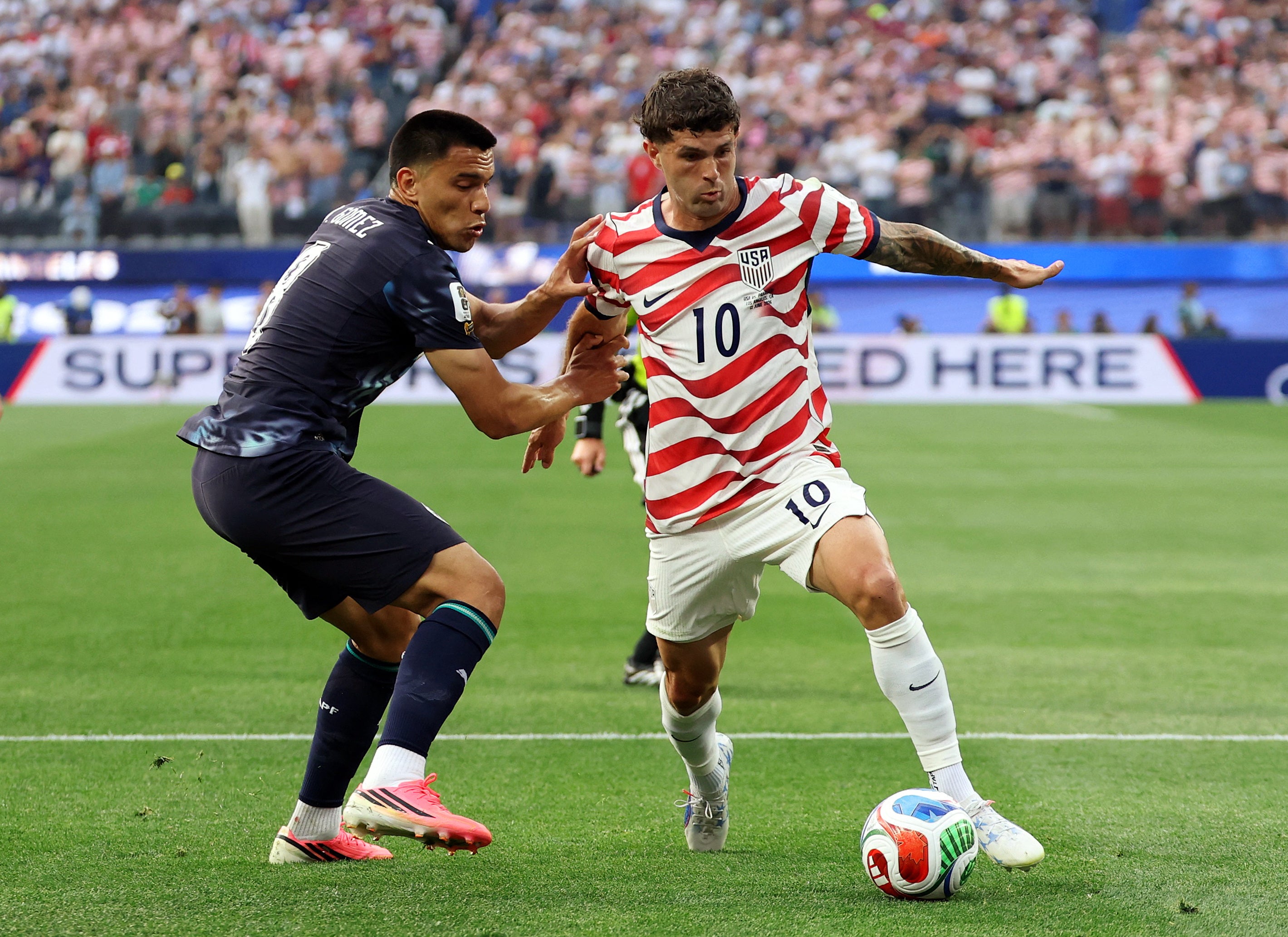 Christian Pulisic of the U.S. in action with Paraguay's Diego Gomez