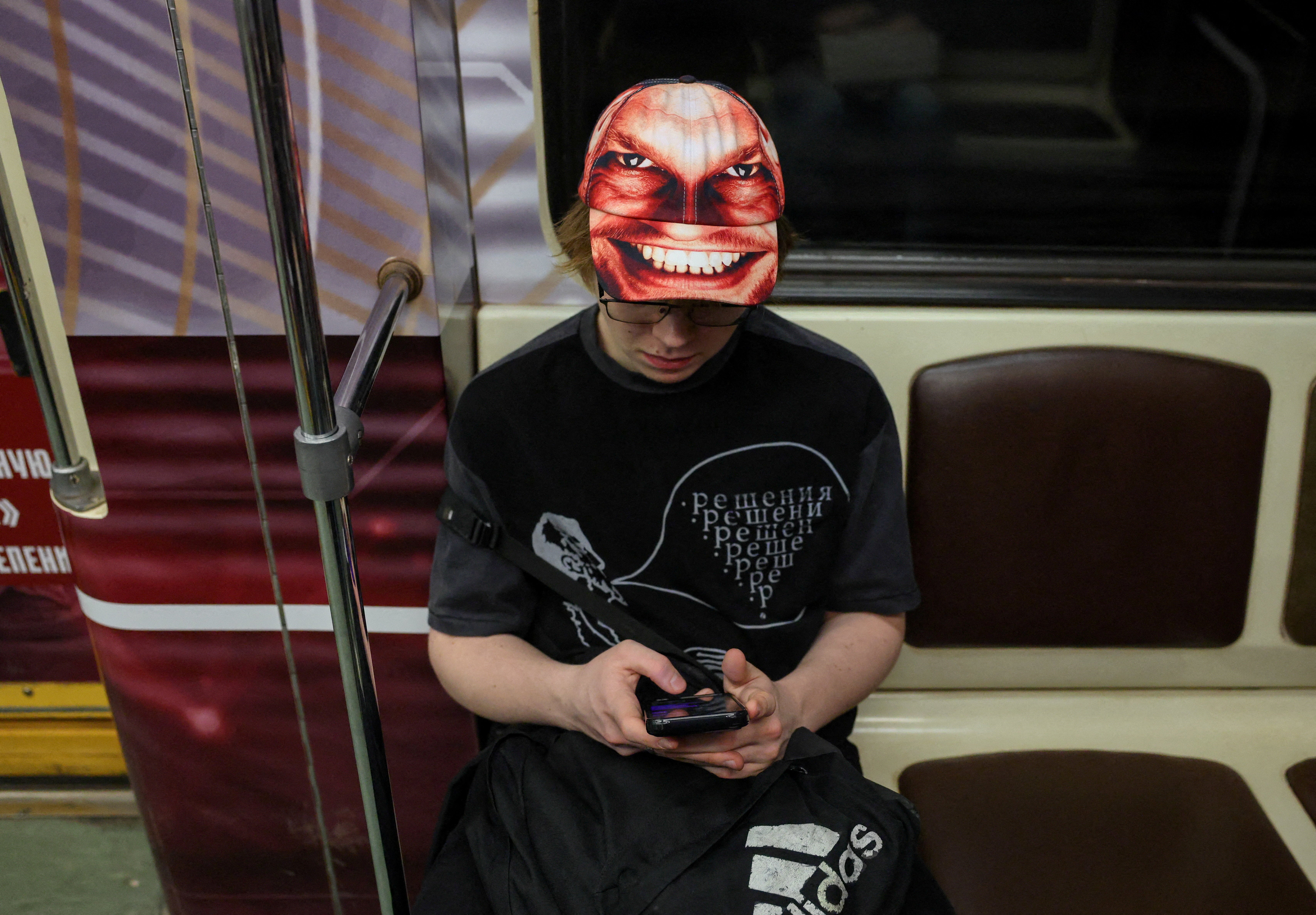 A passenger uses a mobile phone in a metro carriage in Moscow, Russia, March 31, 2026. REUTERS/Ramil Sitdikov/File Photo