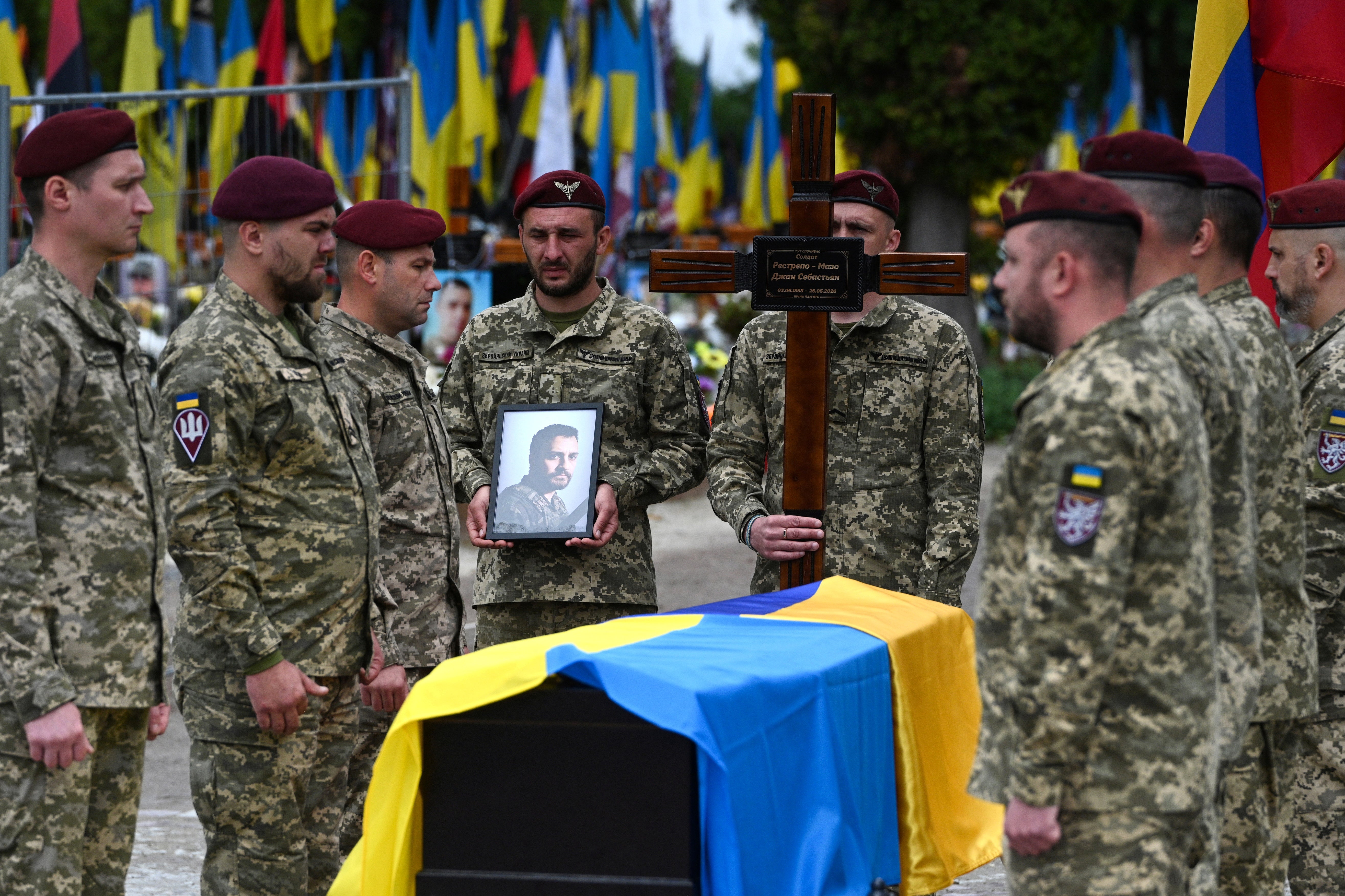 Ukrainian servicemen stand by the coffin of Colombian fighter Jhan Sebastian Restrepo Mazo (AFP/Getty)