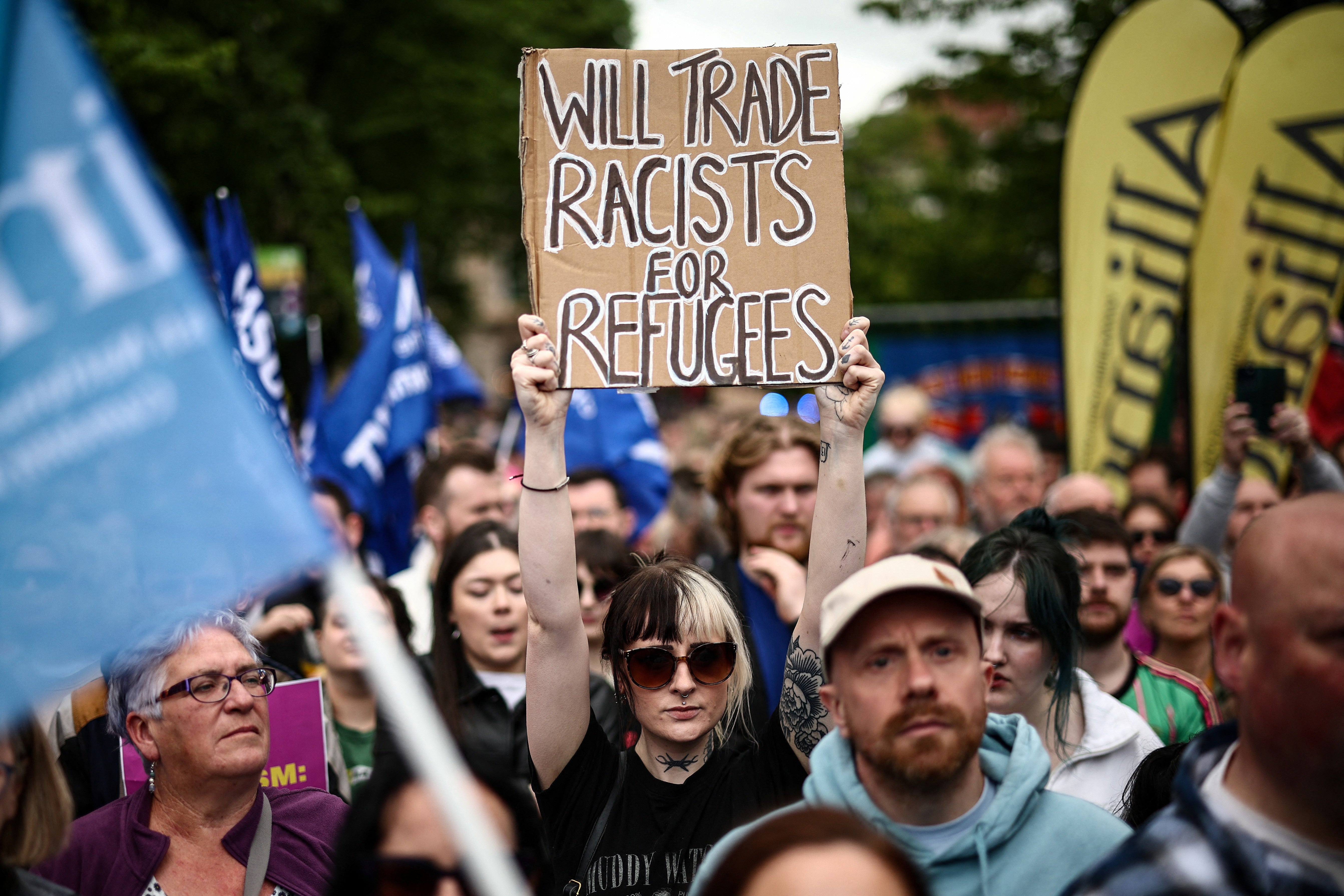 Placards were held up by attendees at the rally (AFP/Getty)