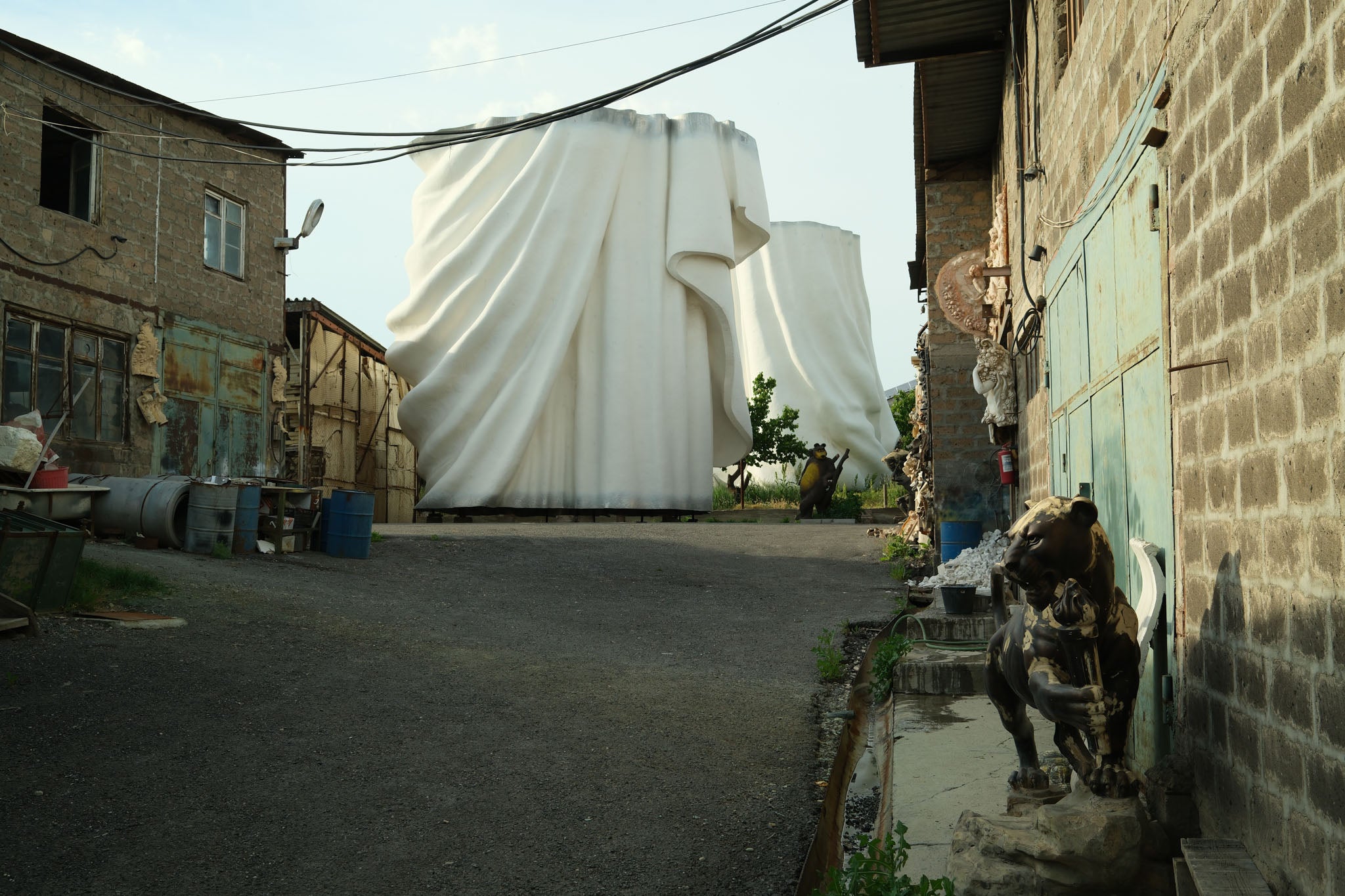 The bottom two-thirds of the giant statue sit in the yard near Yerevan